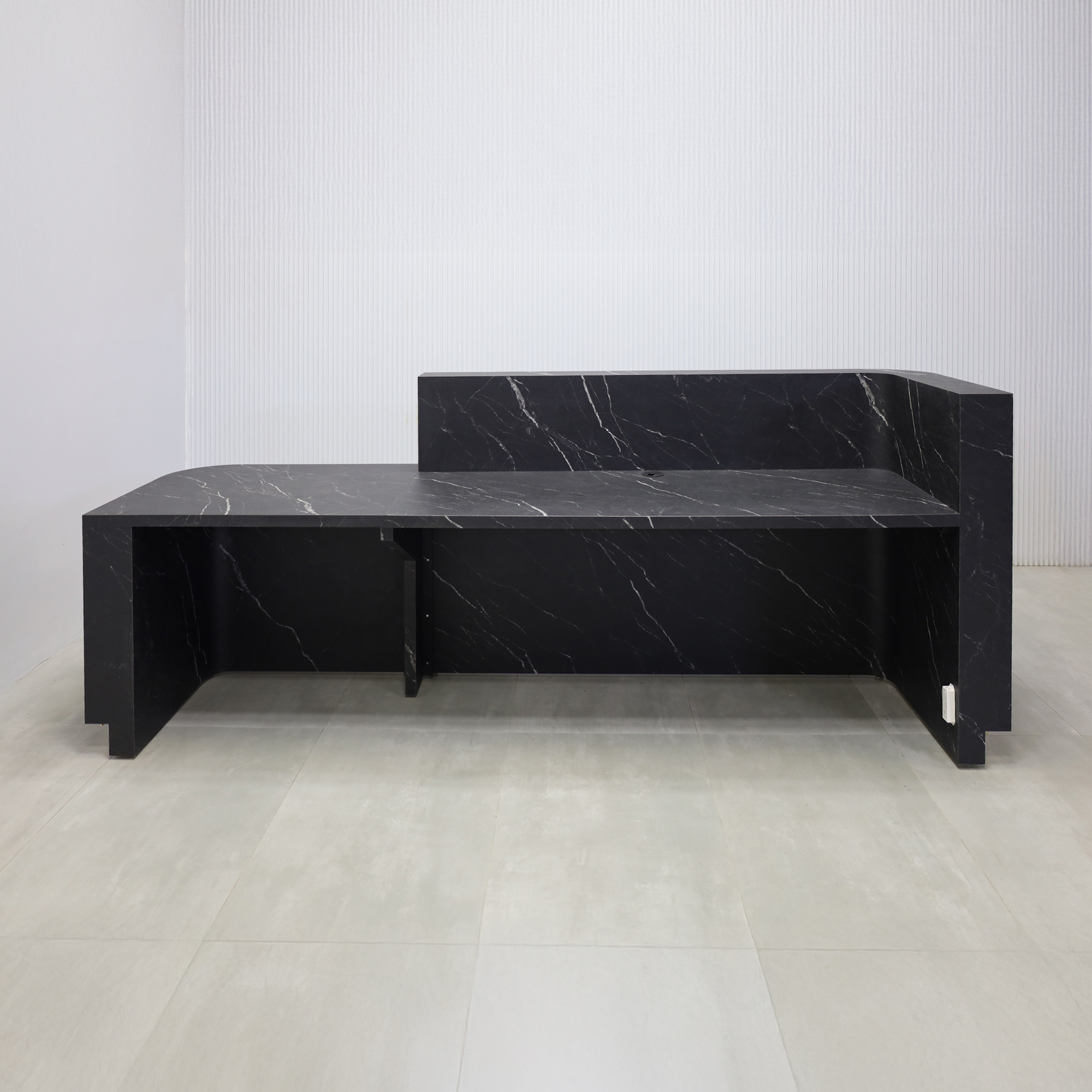108-inch Nola ADA Reception Desk with Black traceless laminate tambour counter & desk, Black Stone Palazzo laminate workspace, gold aluminum toe-kick, warm white LED. 