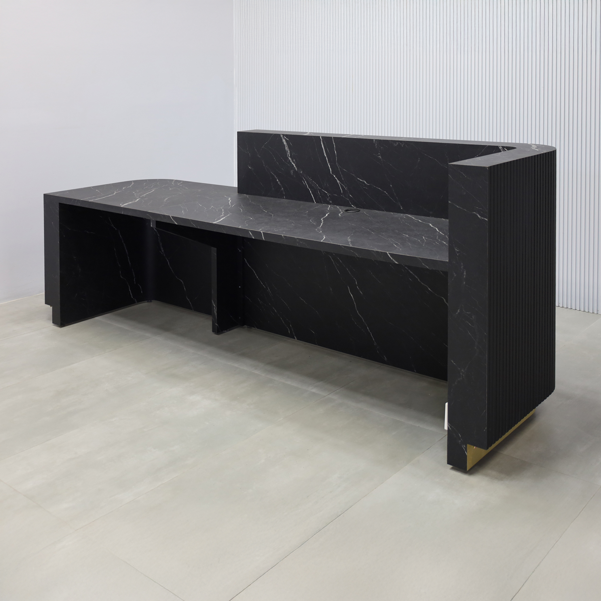 108-inch Nola ADA Reception Desk with Black traceless laminate tambour counter & desk, Black Stone Palazzo laminate workspace, gold aluminum toe-kick, warm white LED. 