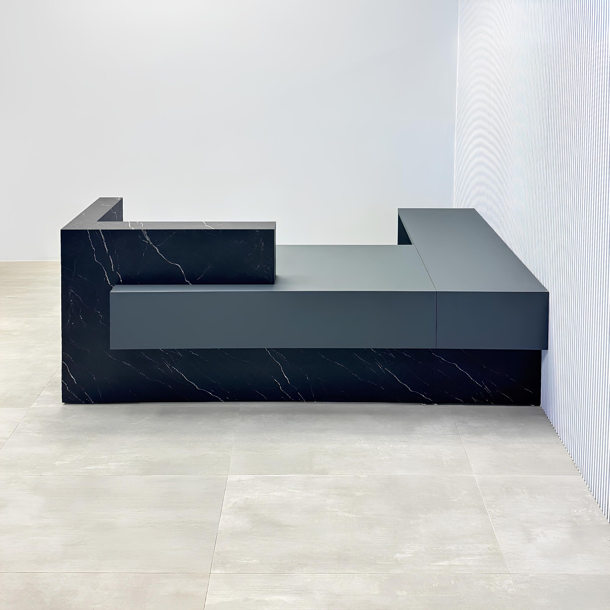 108-inch Atlanta L Reception desk with gray traceless laminate desk, base, and return. Counter top and front accent in black stone palazzo.