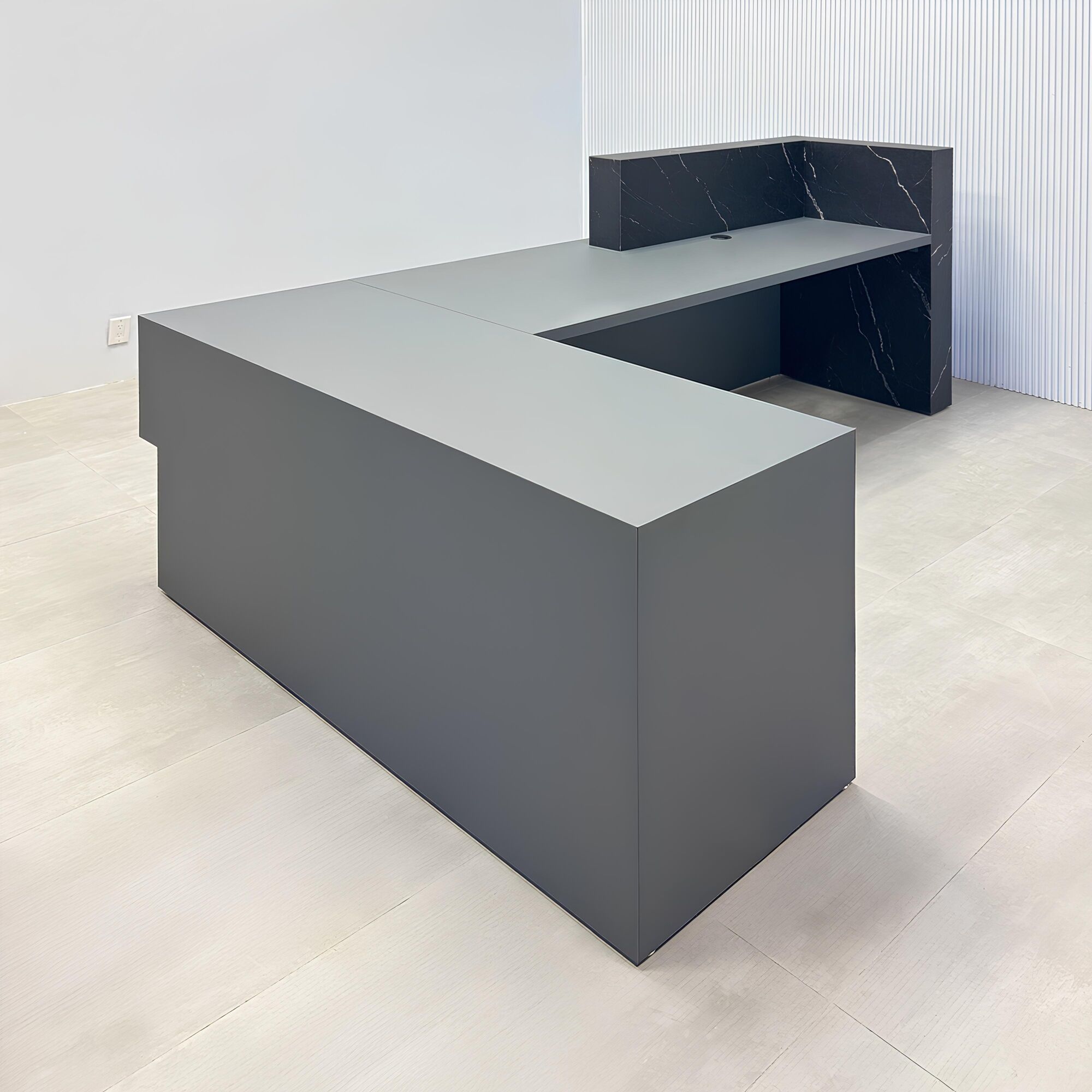 108-inch Atlanta L Reception desk with gray traceless laminate desk, base, and return. Counter top and front accent in black stone palazzo.