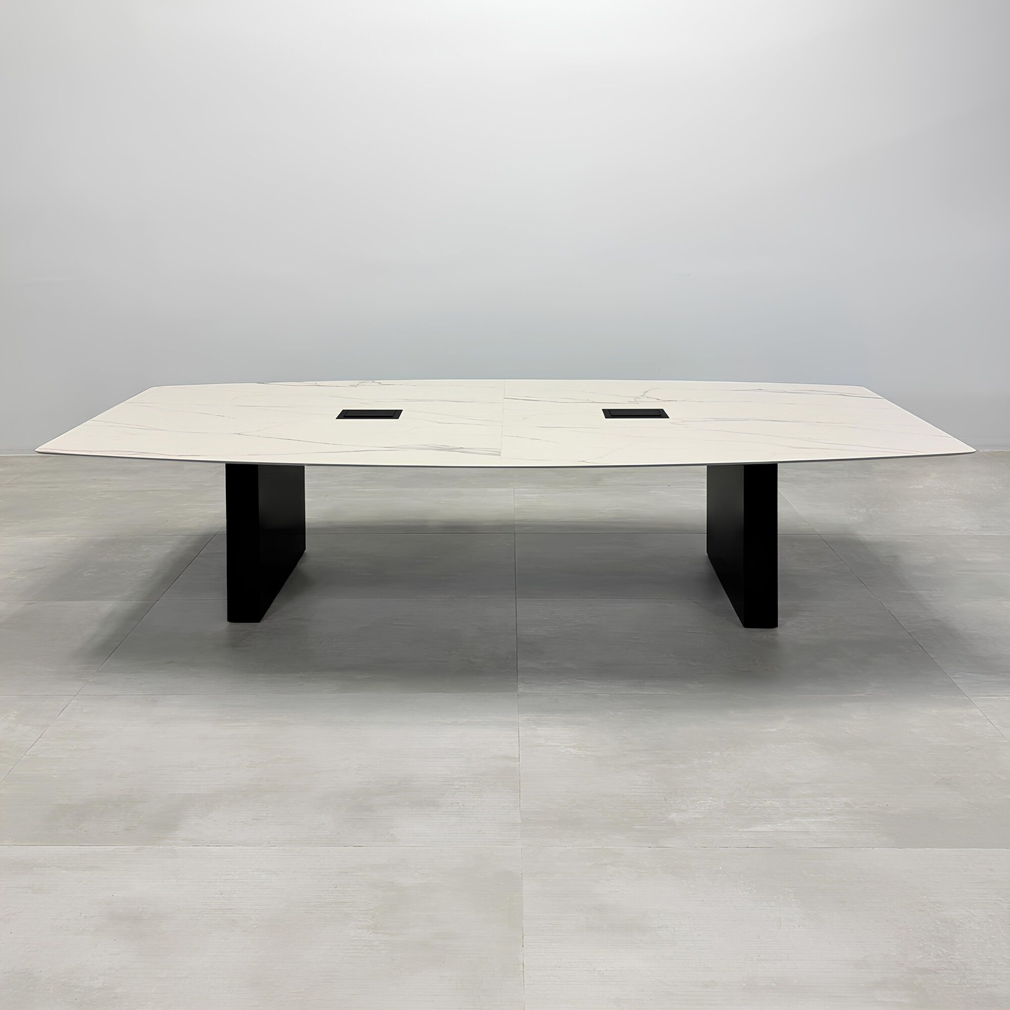 108-inch Aurora Boat Shape Conference Table with solenne marble engineered surface top, black matte laminate base, and Mx3 power box in black. 