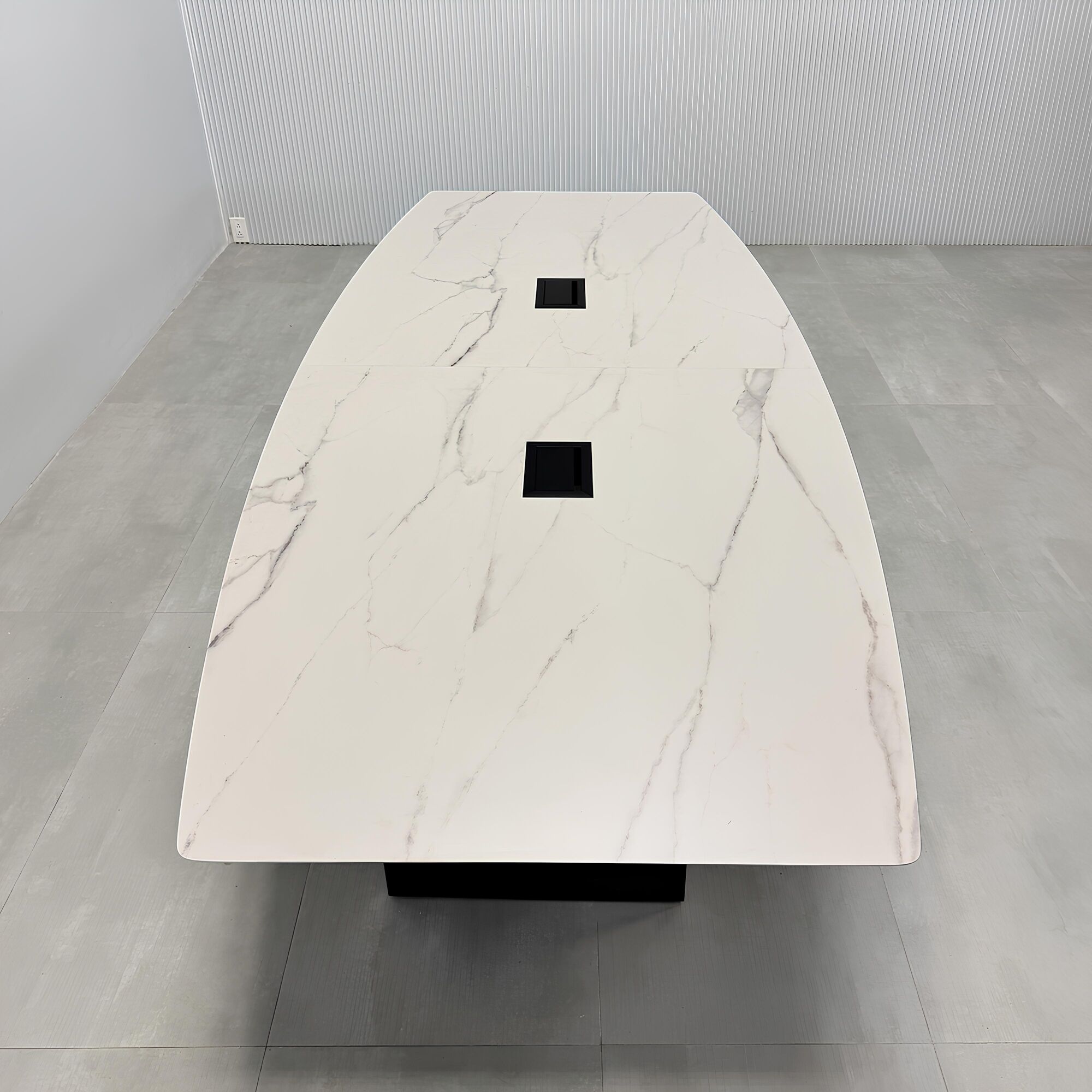 108-inch Aurora Boat Shape Conference Table with solenne marble engineered surface top, black matte laminate base, and Mx3 power box in black. 
