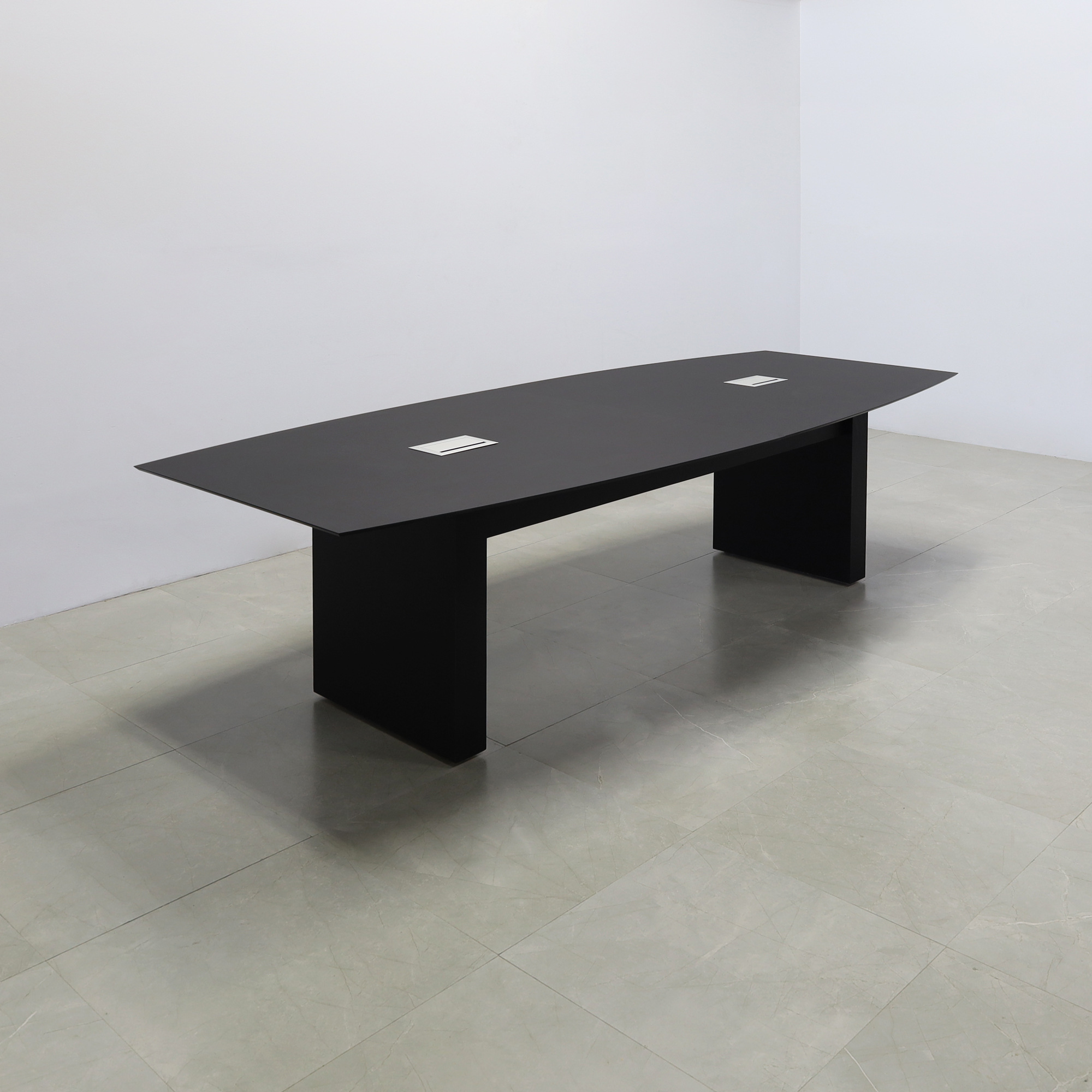 114-inch Aurora Boat Shape Conference Table in 1/2-inch black traceless engineered surface top, standard base black matte laminate, and two silver MX3 power boxes.