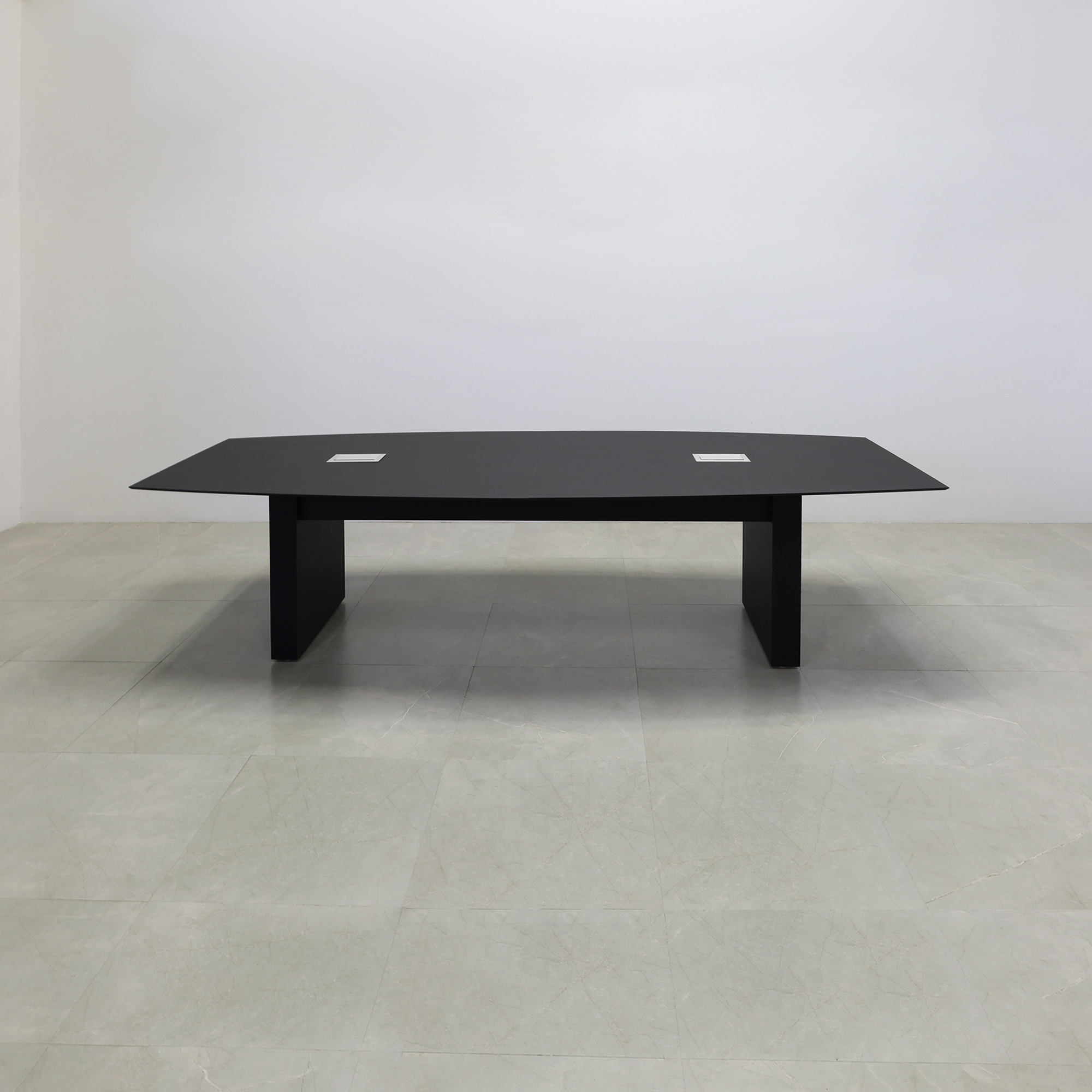 114-inch Aurora Boat Shape Conference Table in 1/2-inch black traceless engineered surface top, standard base black matte laminate, and two silver MX3 power boxes.