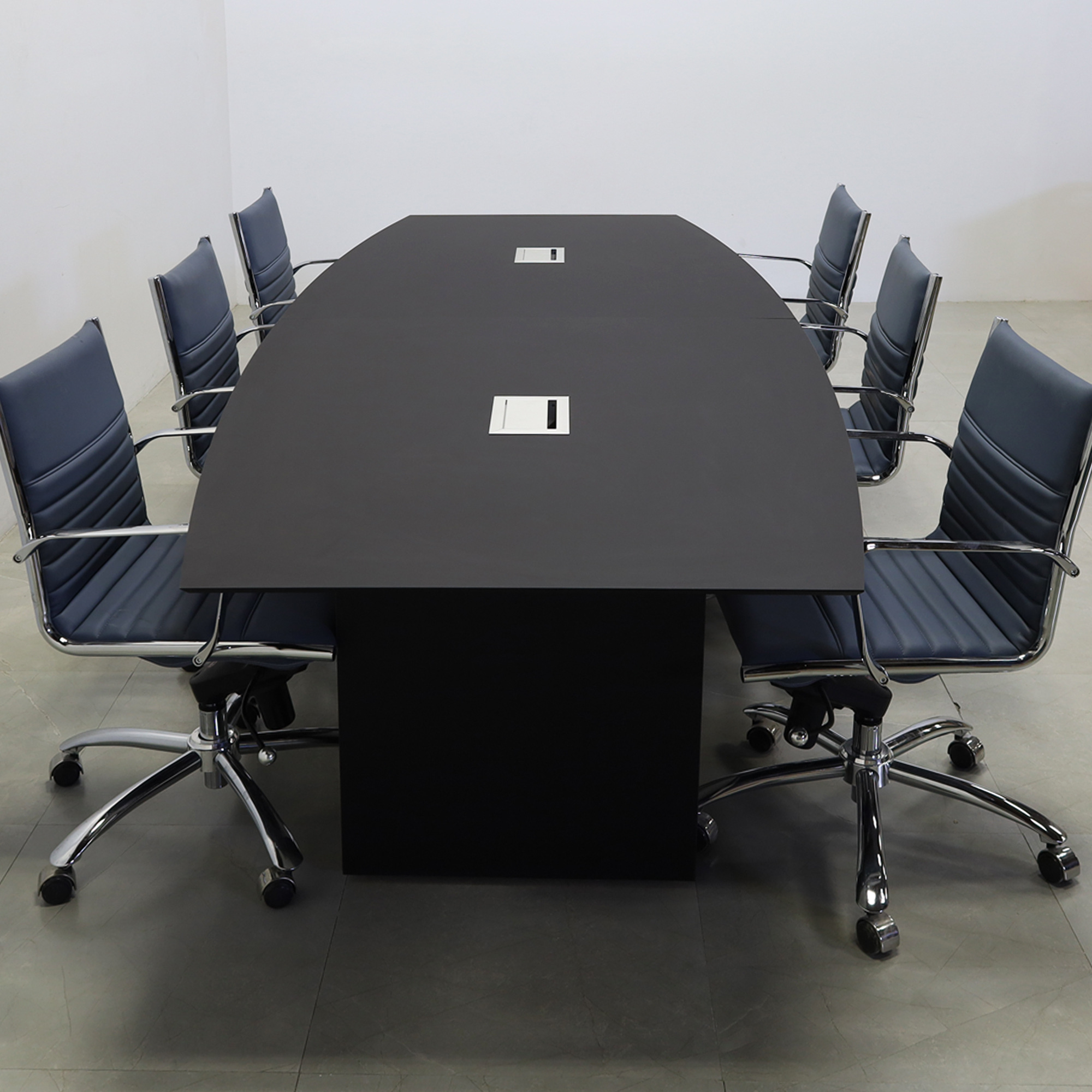 114-inch Aurora Boat Shape Conference Table in 1/2-inch black traceless engineered surface top, standard base black matte laminate, and two silver MX3 power boxes.