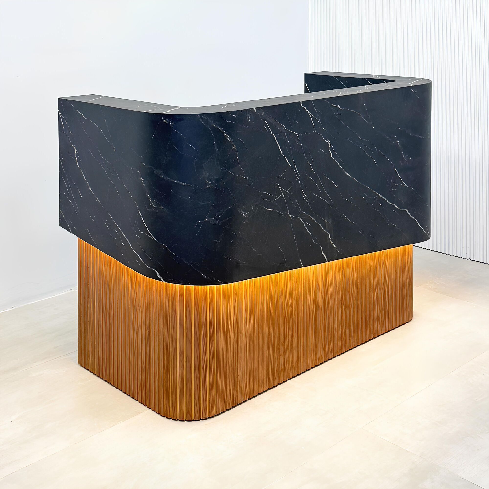 72-inch Nola Curved Custom Reception Desk in black traceless laminate counter, maple tambour bottom, and warm white LED.