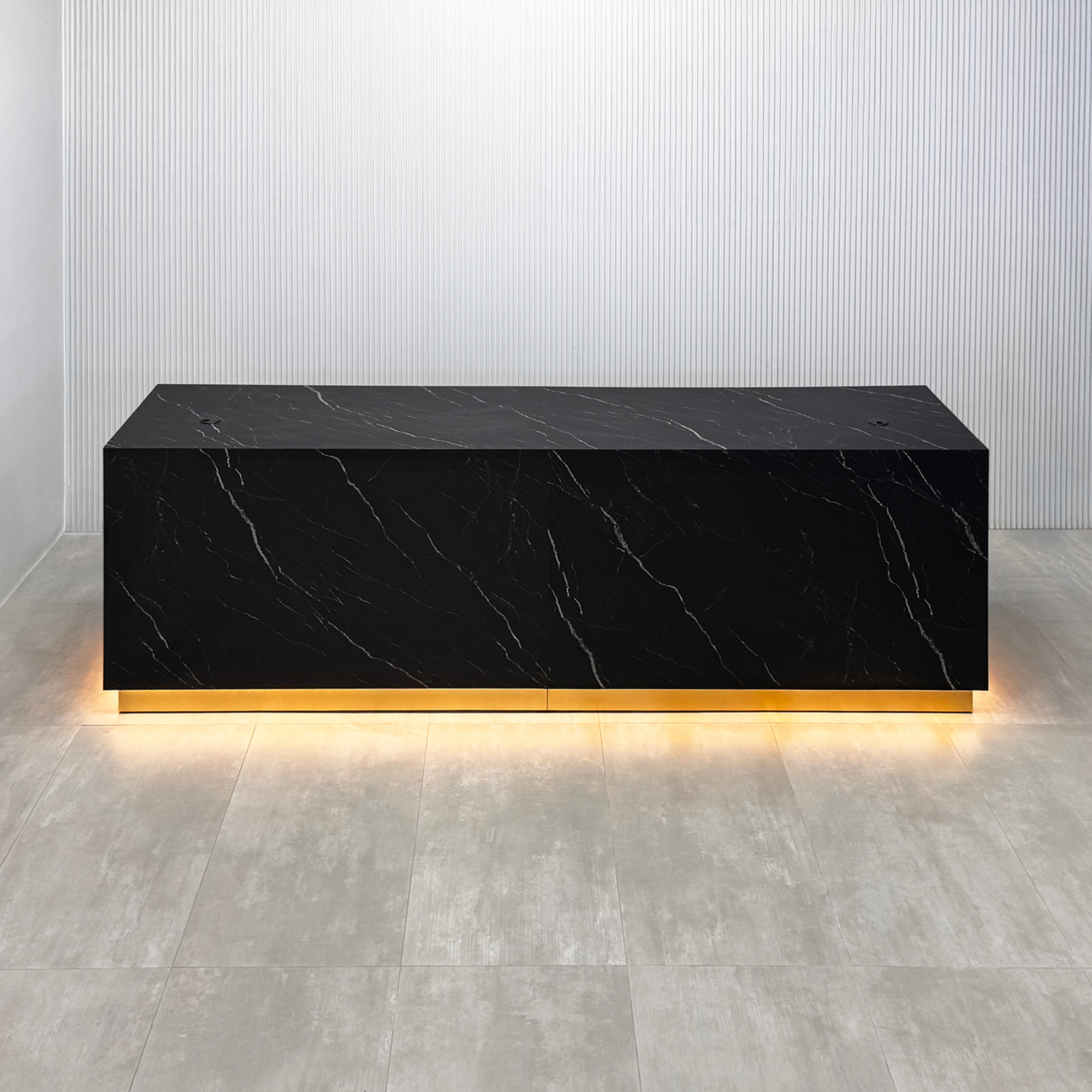 122-inch Houston Custom Reception Desk with Black Stone Palazzo matte laminate Top, Black Stone Palazzo matte laminate Main Desk, Gold aluminum Toe-Kick, and warm white LED.
