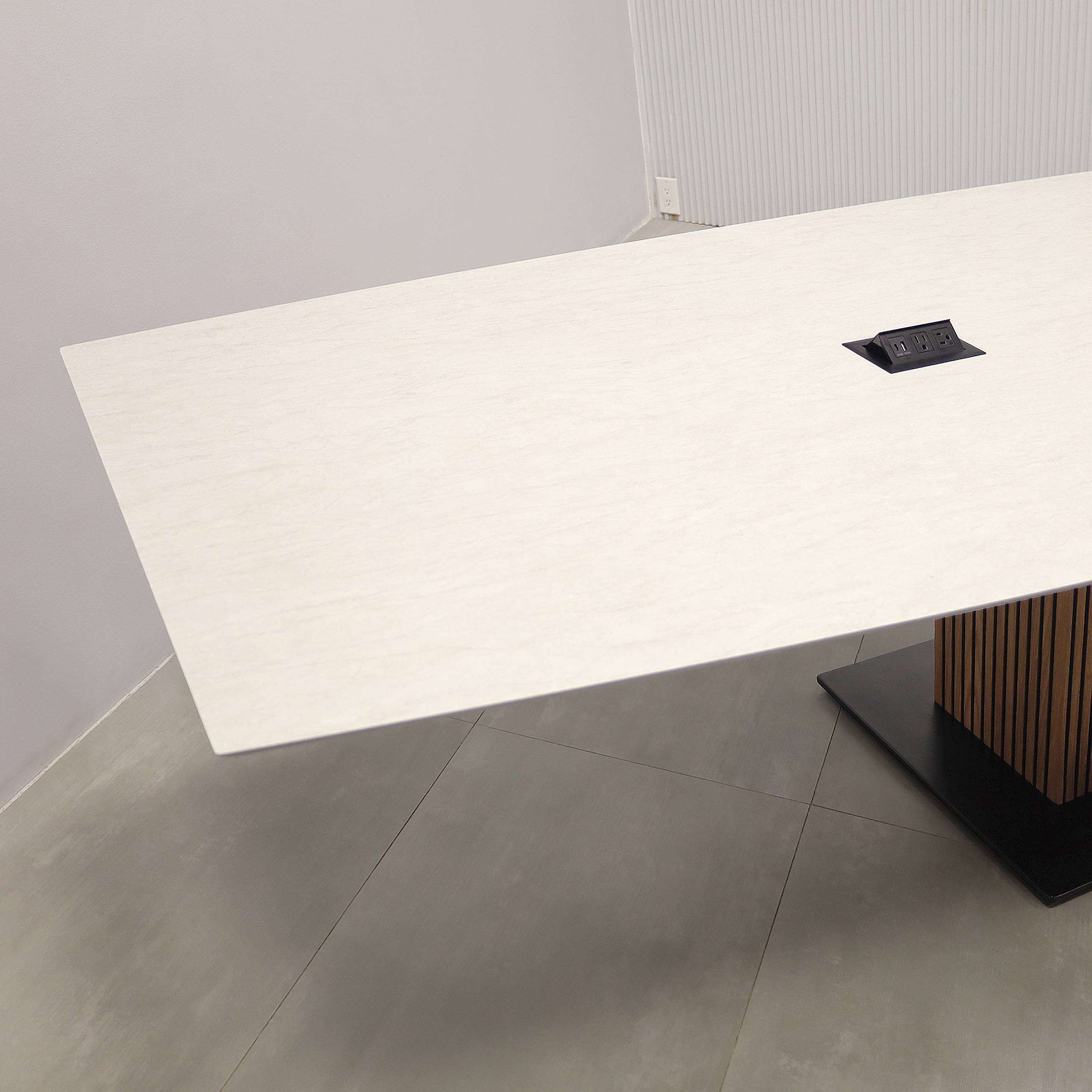 168-inch Aurora Boat Conference Table with Spanish Limestone engineered surface top, walnut tambour & black background pedestal, metal powder-coated black base, and 2 Mx2 power boxes. 