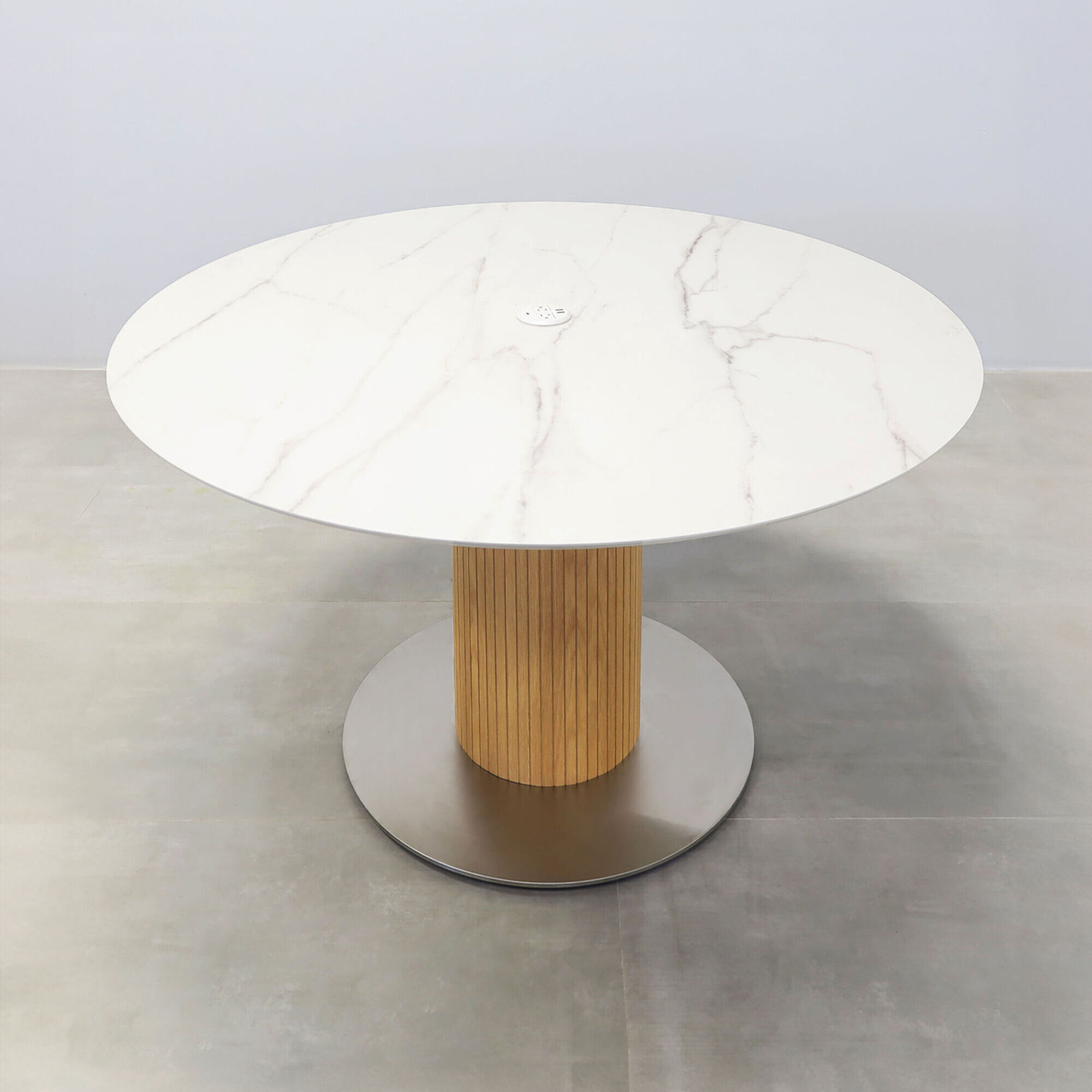 54-inches California X2 Round Conference Table with calcutta blanc engineered surface top, maple tambour pedestal, brushed stainless steel base, and Mx1 in white power box.