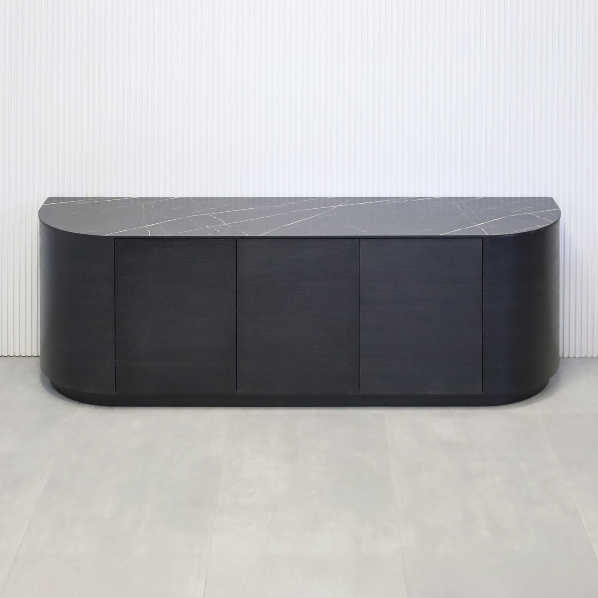 84-inch Milano Curved Storage Credenza with Pietra Noir Engineered Surface Top, Ebony wood veneer credenza & doors, and Ebony wood veener toe-kick.