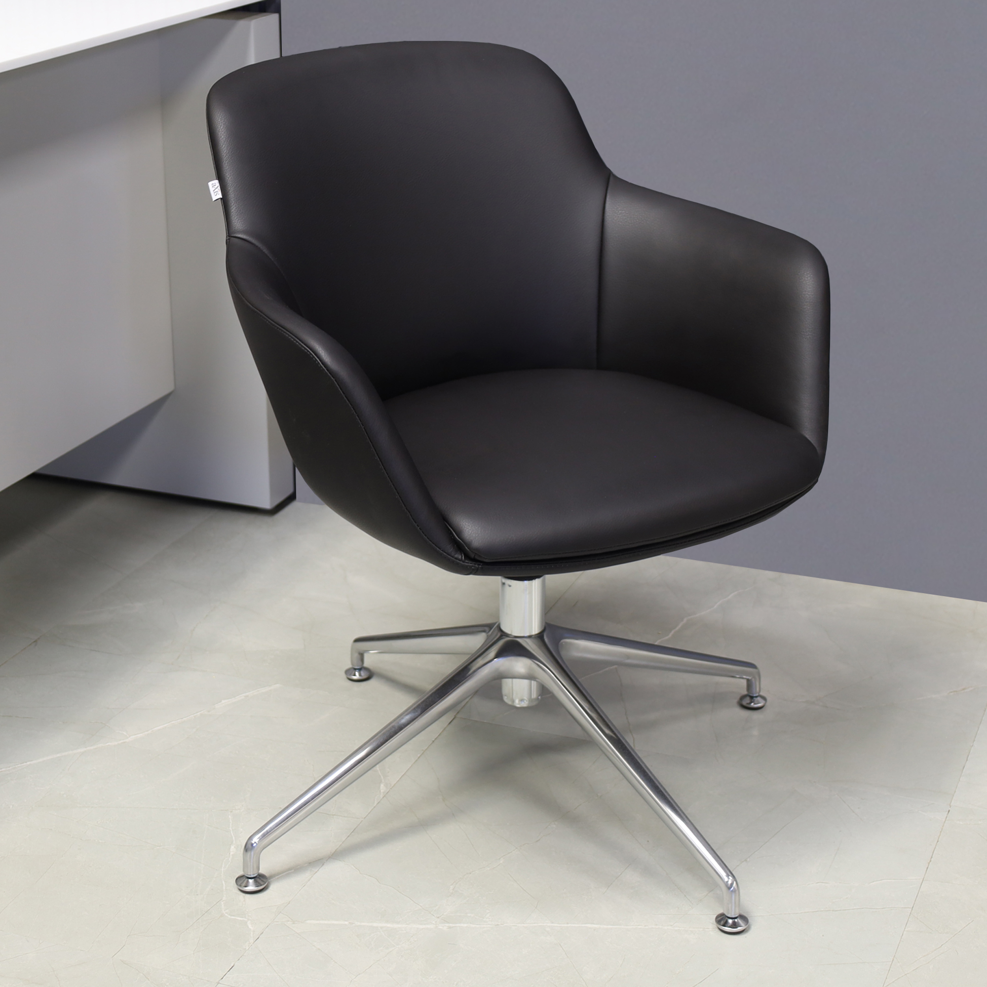 Pavia Guest Chair in black leatherette, shown here.
