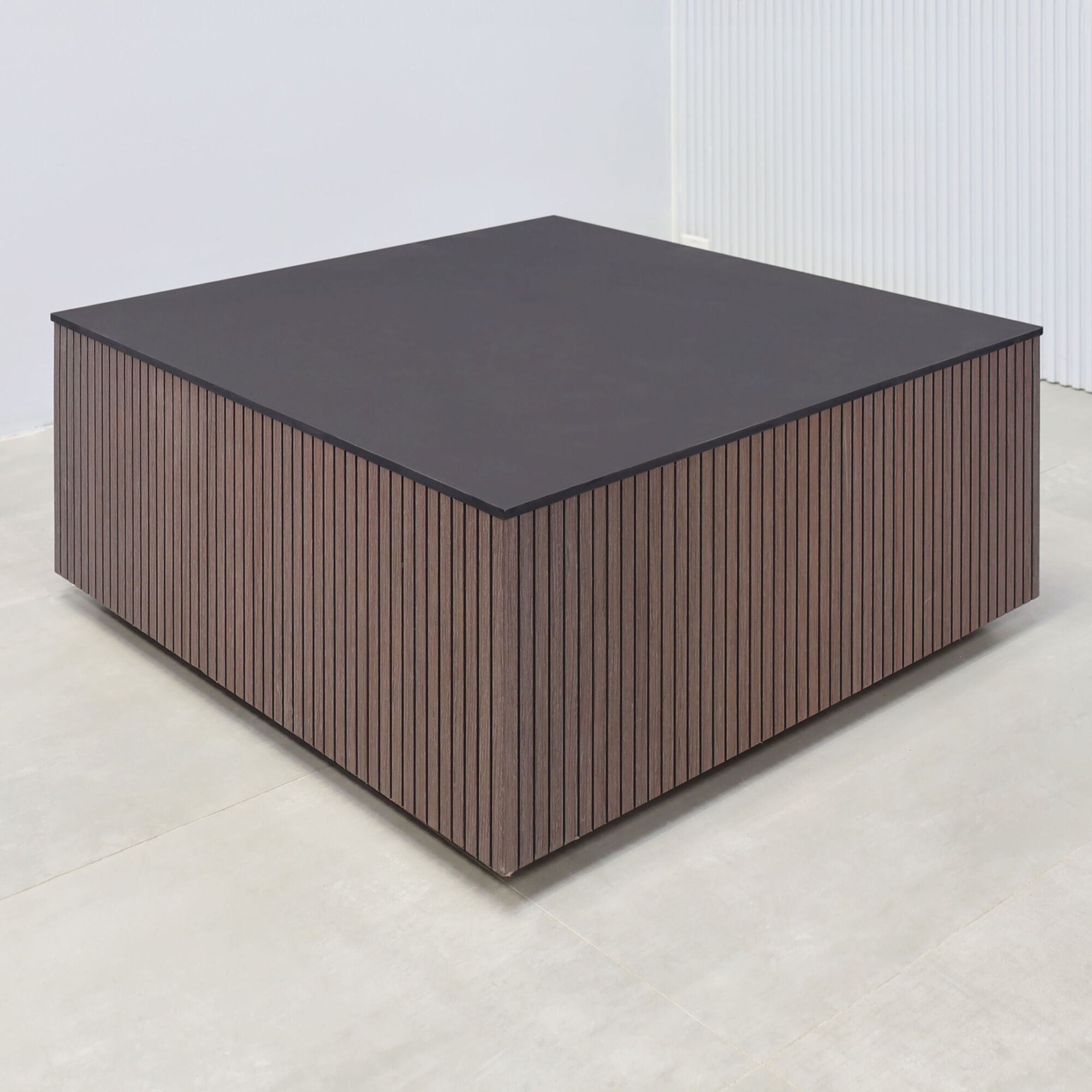 35-inch Norfolk Square Lobby Table with black traceless engineered surface top, walnut tambour with black backgroun side table, black traceless laminate toe-kick.