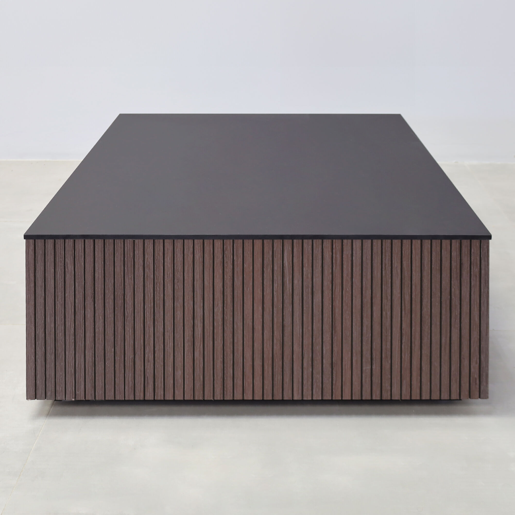 35-inch Norfolk Square Lobby Table with black traceless engineered surface top, walnut tambour with black backgroun side table, black traceless laminate toe-kick.