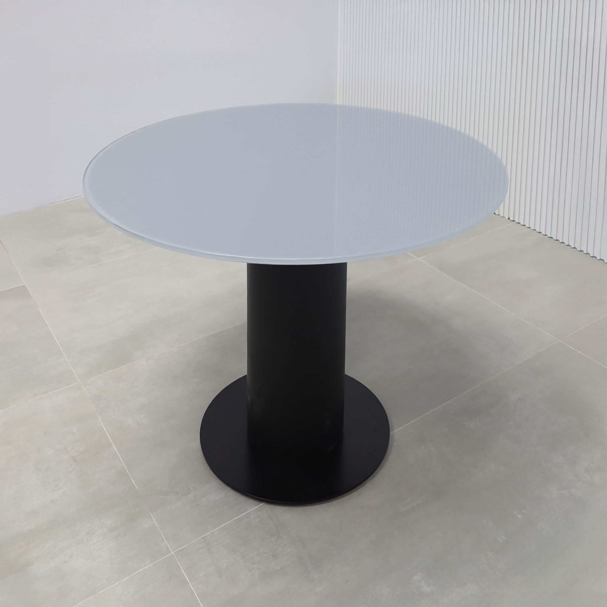 36-inch California X2 Round Cafeteria Table in 1/2-inch dark gray tempered glass top, black traceless laminate pedestal, and metal powder-coated black base. 