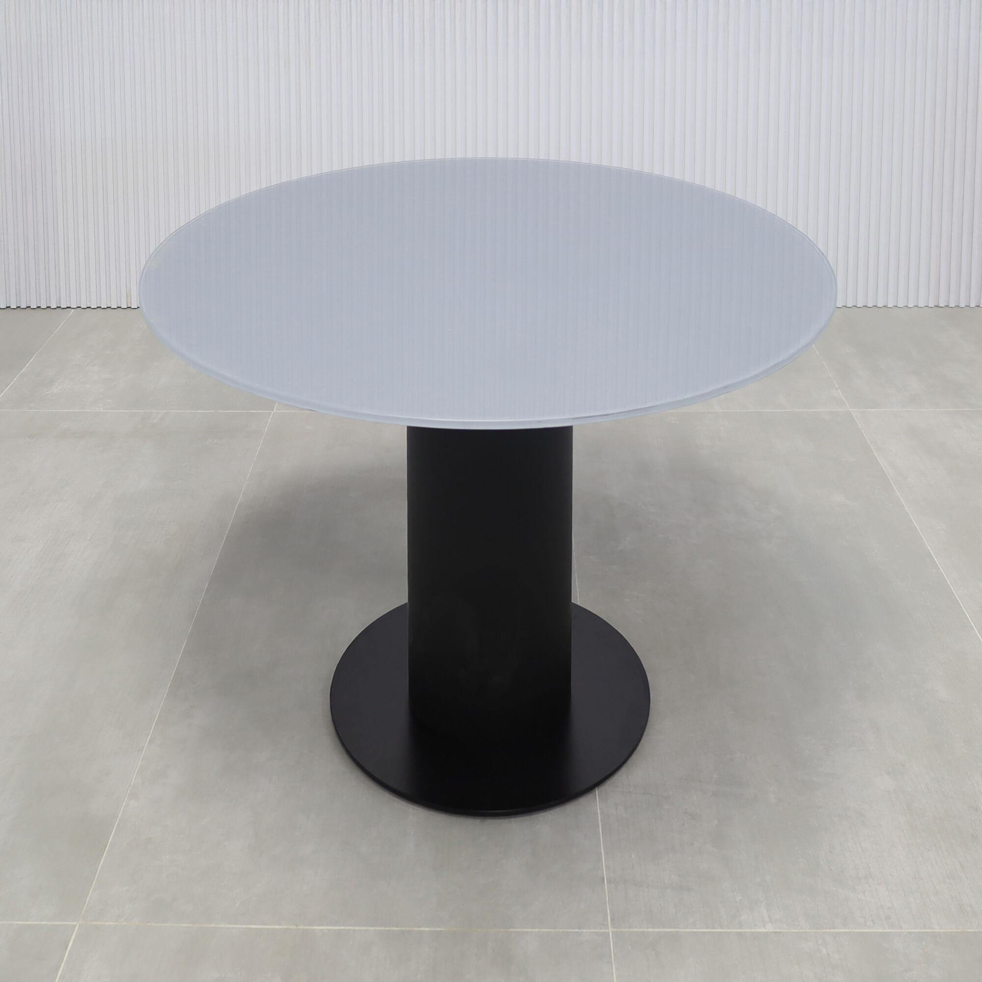 36-inch California X2 Round Cafeteria Table in 1/2-inch dark gray tempered glass top, black traceless laminate pedestal, and metal powder-coated black base. 