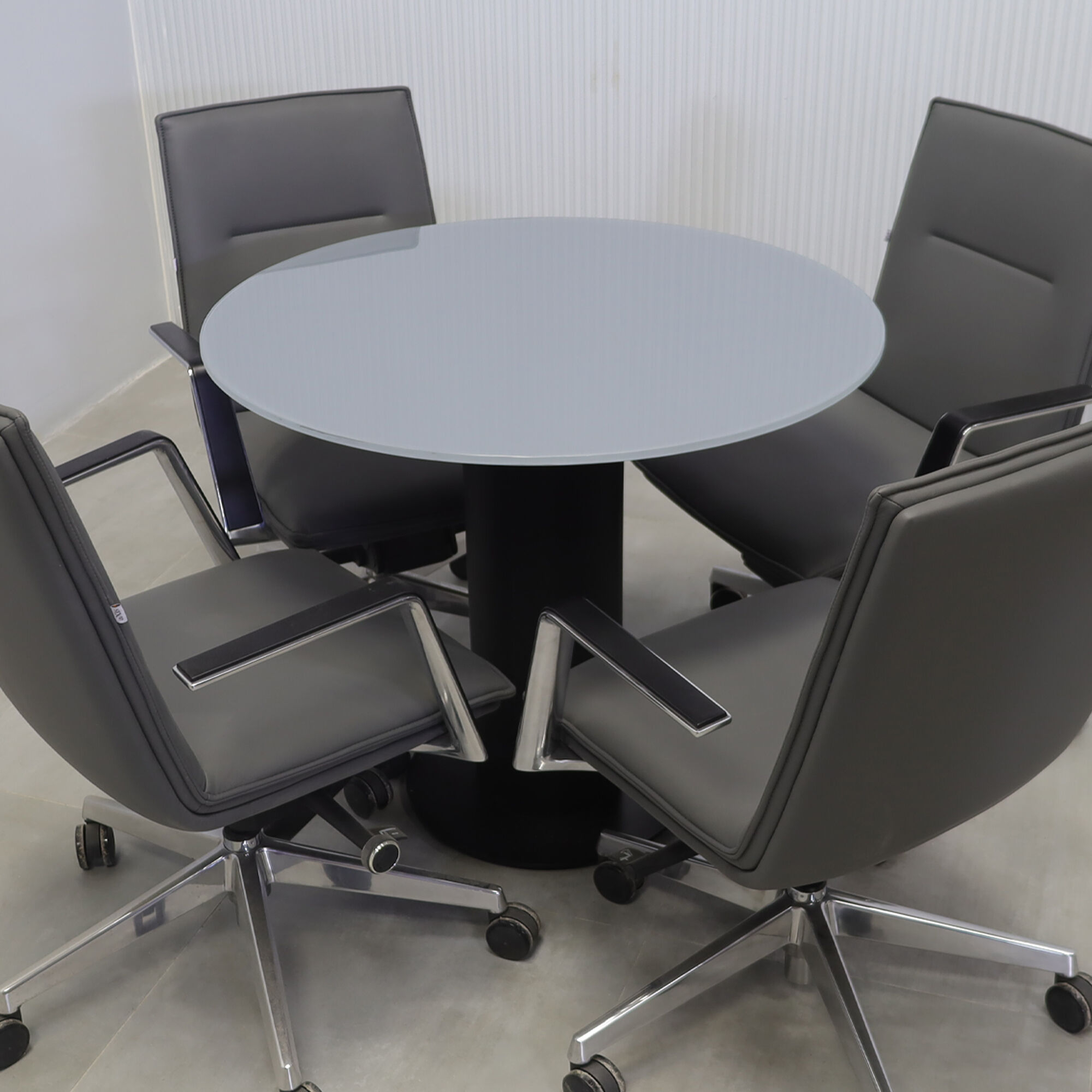 36-inch California X2 Round Cafeteria Table in 1/2-inch dark gray tempered glass top, black traceless laminate pedestal, and metal powder-coated black base. 