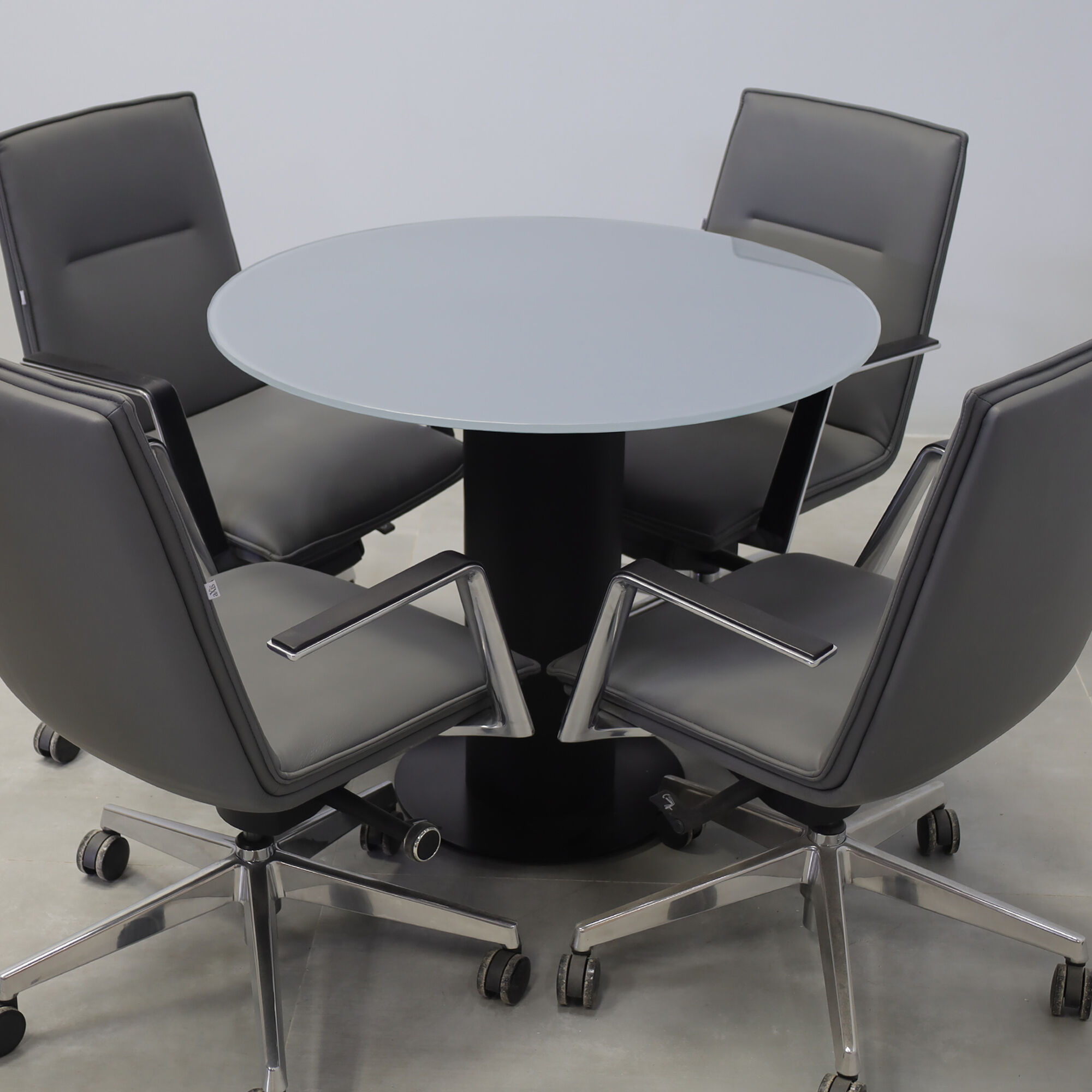 36-inch California X2 Round Cafeteria Table in 1/2-inch dark gray tempered glass top, black traceless laminate pedestal, and metal powder-coated black base. 