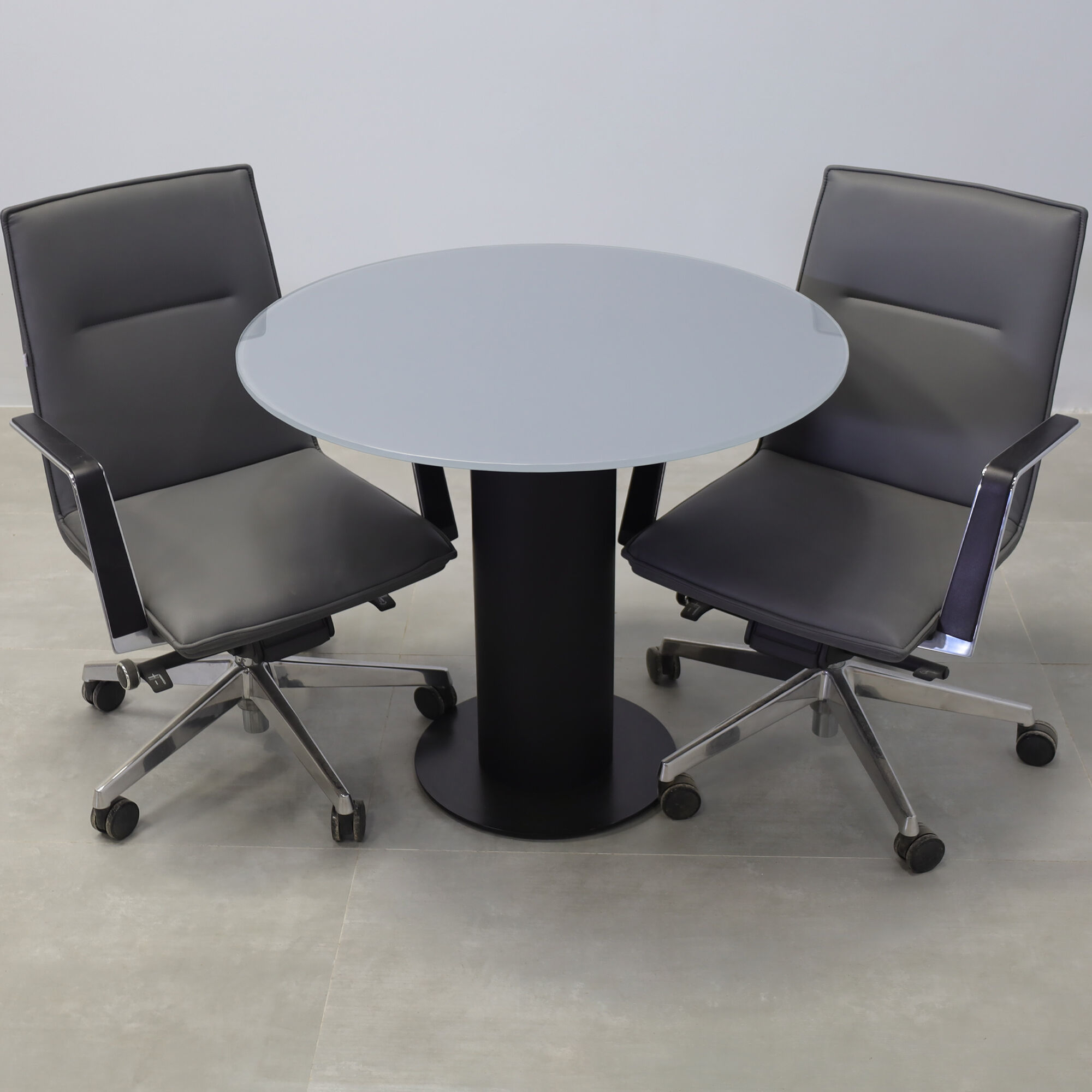 36-inch California X2 Round Cafeteria Table in 1/2-inch dark gray tempered glass top, black traceless laminate pedestal, and metal powder-coated black base. 