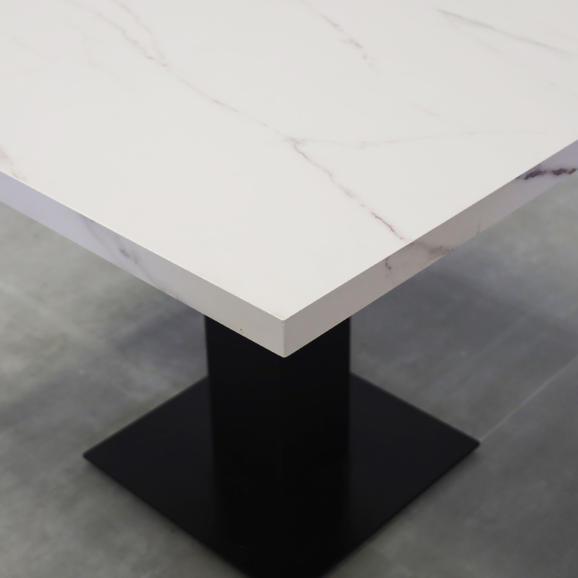 40-inch California X2 Round Conference Table in 1 1/2-inch solenne marble engineered surface top, black traceless laminate pedestal, metal powder coated base in black.