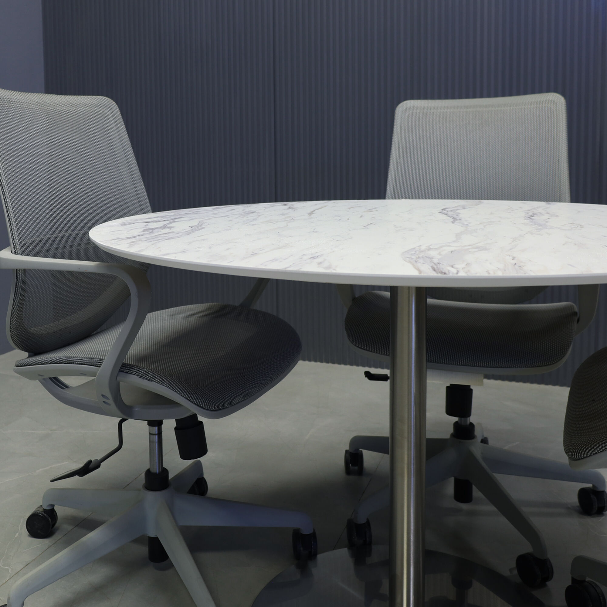 42-inch California Round Conference Table with 1/2-inch calcutta blanc engineered surface top and silver metal powder-coated base.
