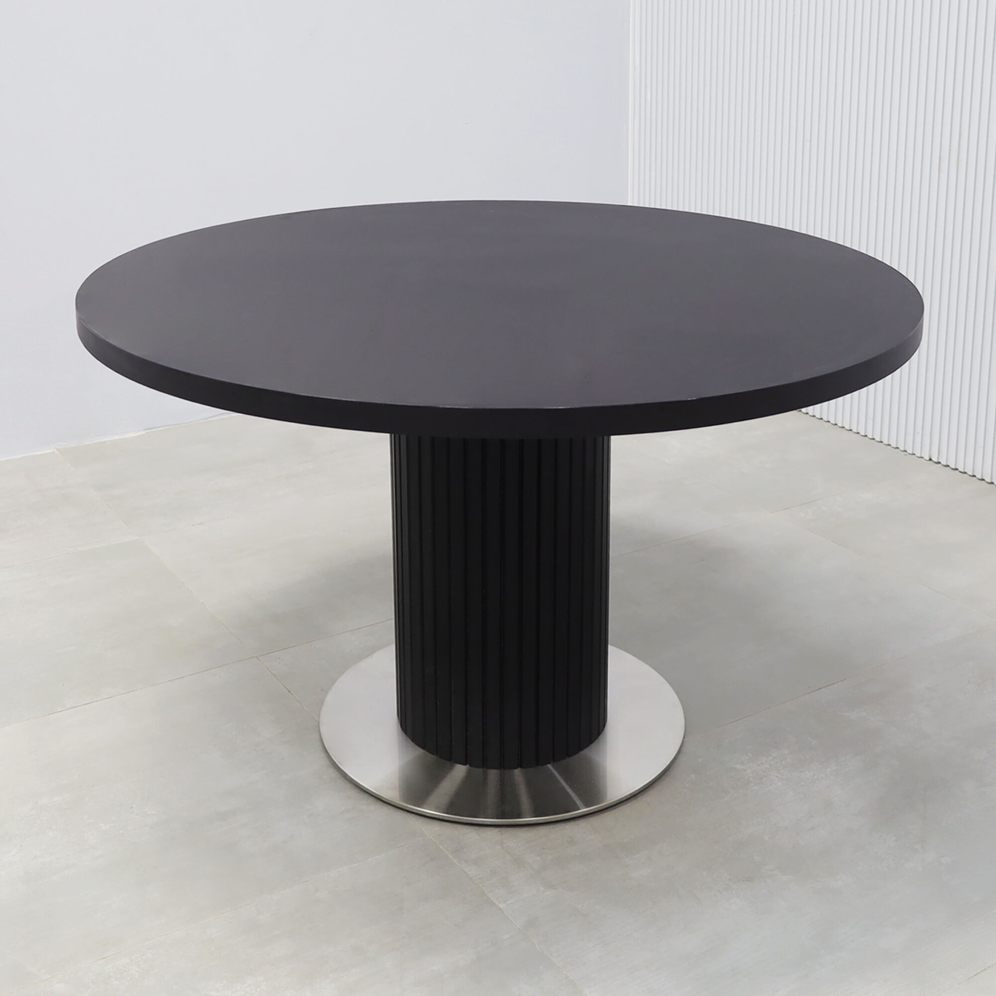 47-inch Newton X3 Round Conference Table with black matte laminate top, black traceless tambour pedestal, and silver stainless steel base.