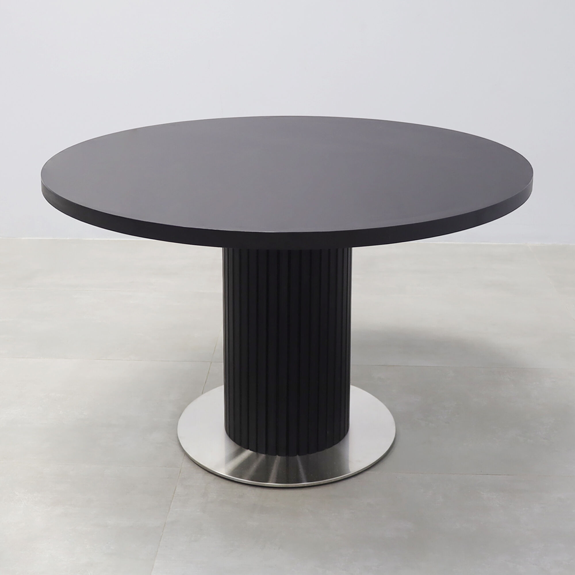 47-inch Newton X3 Round Conference Table with black matte laminate top, black traceless tambour pedestal, and silver stainless steel base.