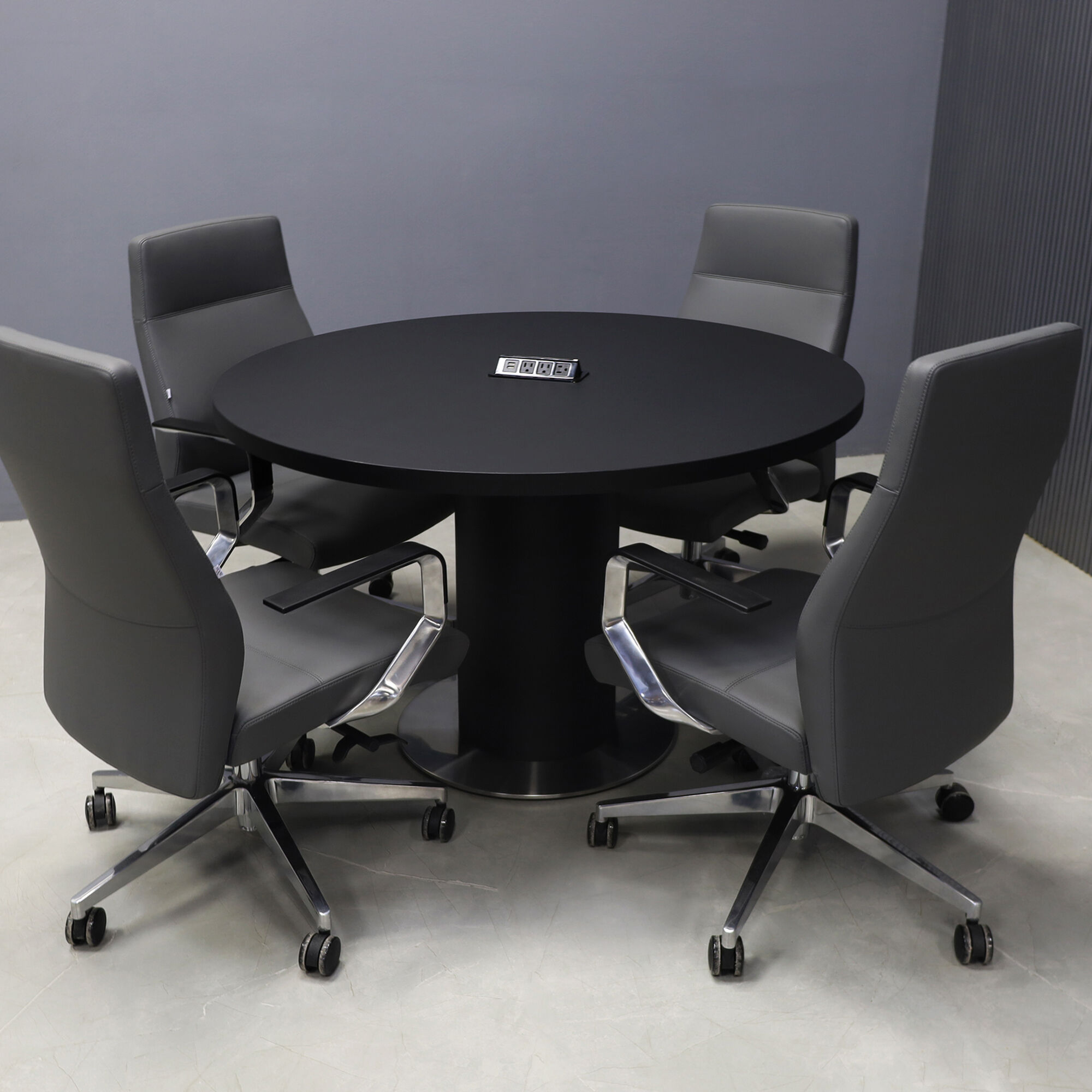 48-inch Newton Round  With Laminate Top & pedestal in black traceless laminate, silver metal powder-coated base, and black power box.