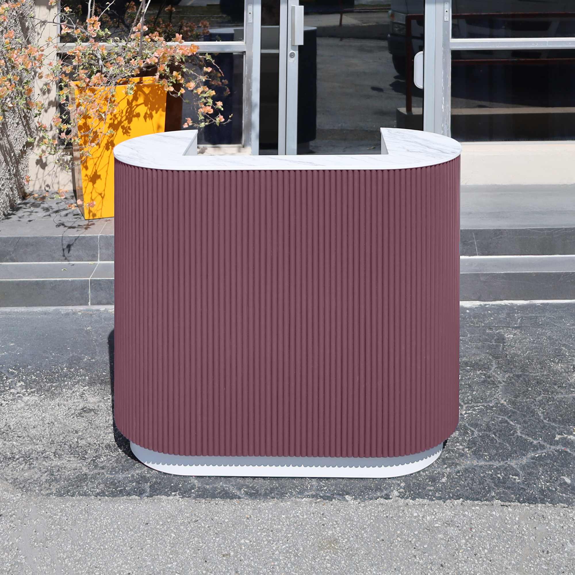 48-inch The Pill X2 Podium & Host Custom Desk with Dover Off-White matte laminate desk, and Benjamin Moore (Special Solid Wood Tambour Color). Calcutta Blanc engineered surface top, and Dover Off-White matte laminate toe-kick.
