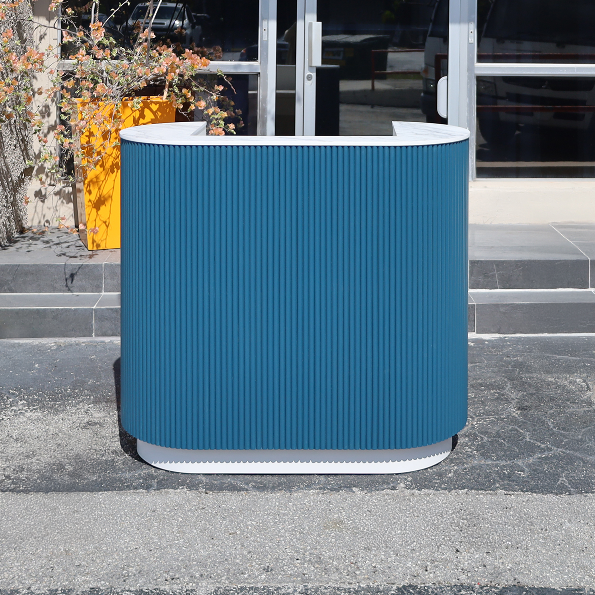 48-inch The Pill Podium Desk with Dover Off-White matte laminate workspace, hand-painted Sapphire CSP-690 Benjamin Moore solid wood tambour accent, and Dover Off-White matte laminate toe-kick.