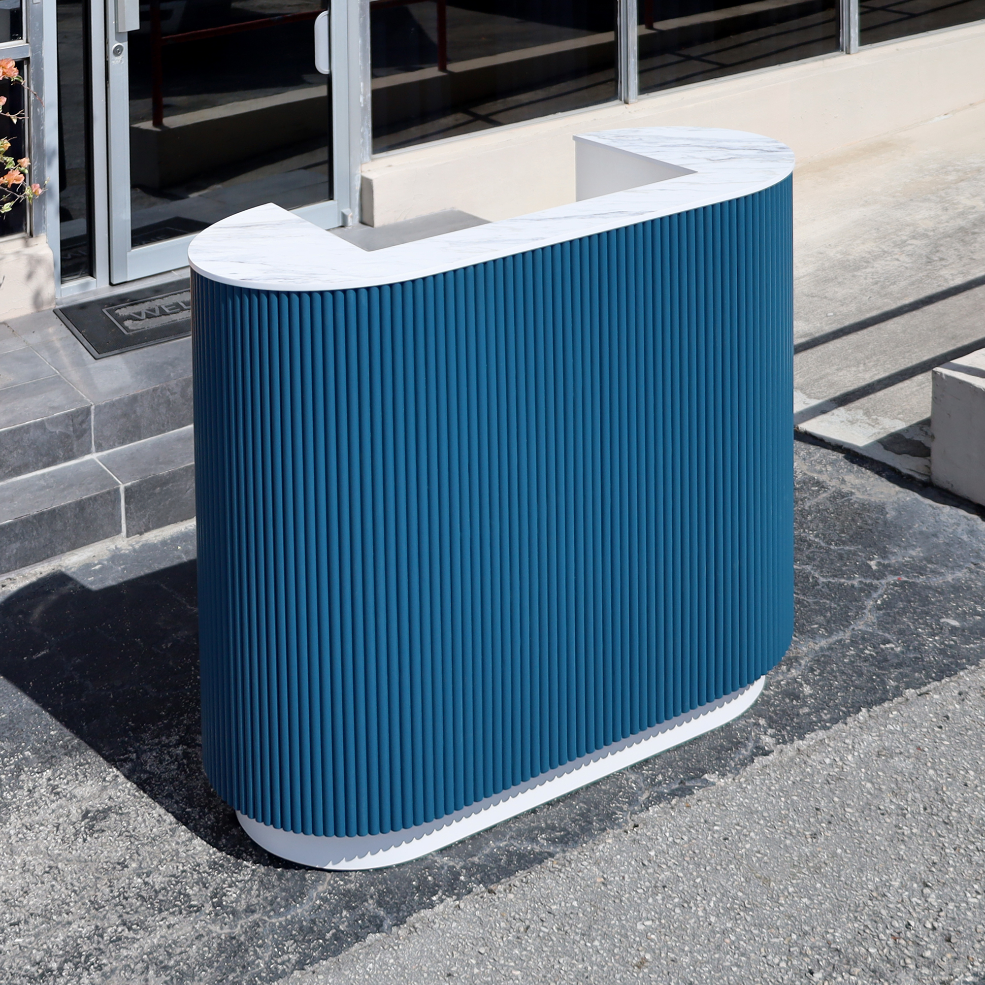 48-inch The Pill Podium Desk with Dover Off-White matte laminate workspace, hand-painted Sapphire CSP-690 Benjamin Moore solid wood tambour accent, and Dover Off-White matte laminate toe-kick.