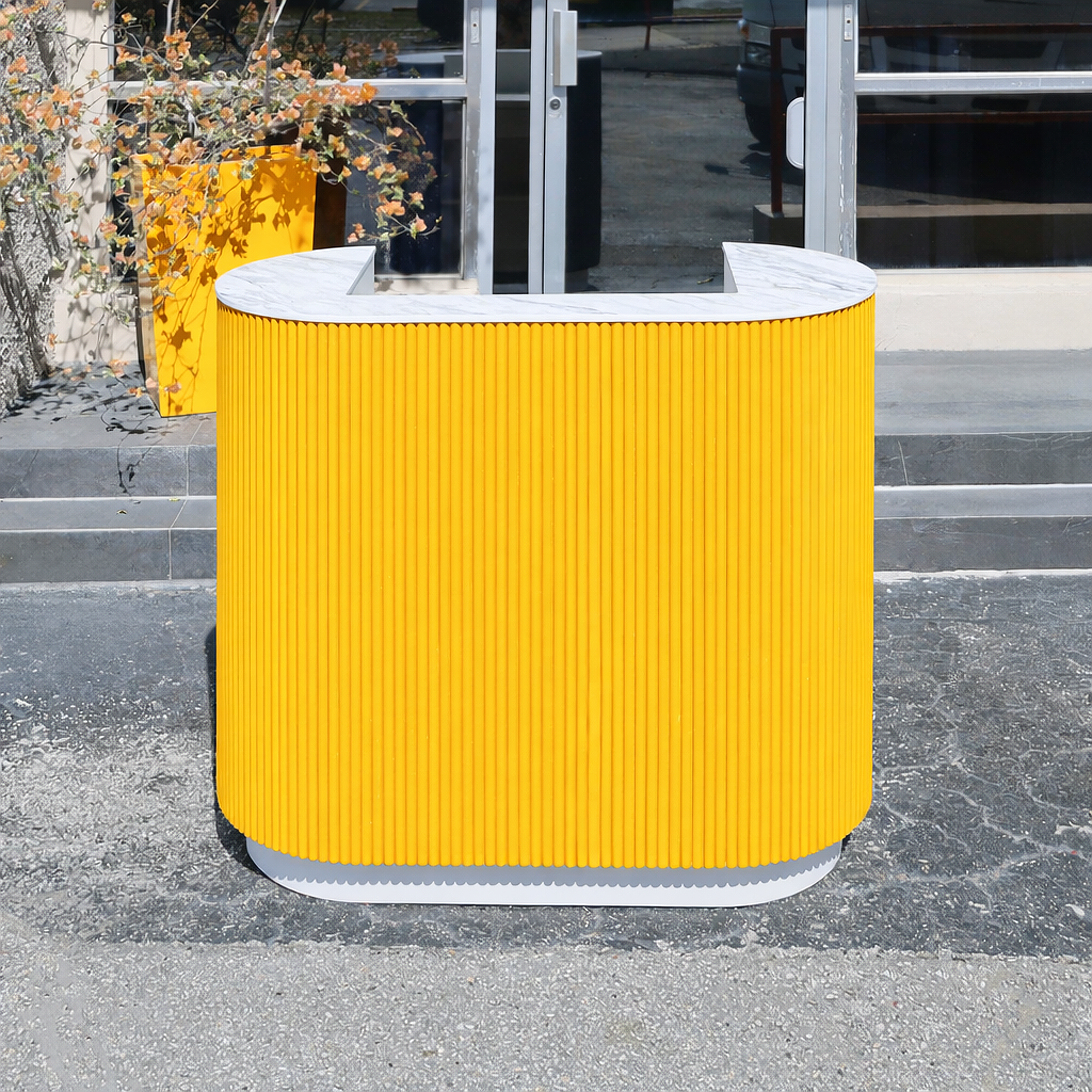 48-inch The Pill X2 Podium & Host Custom Desk with Dover Off-White matte laminate desk, and Benjamin Moore (Special Solid Wood Tambour Color). Calcutta Blanc engineered surface top, and Dover Off-White matte laminate toe-kick.