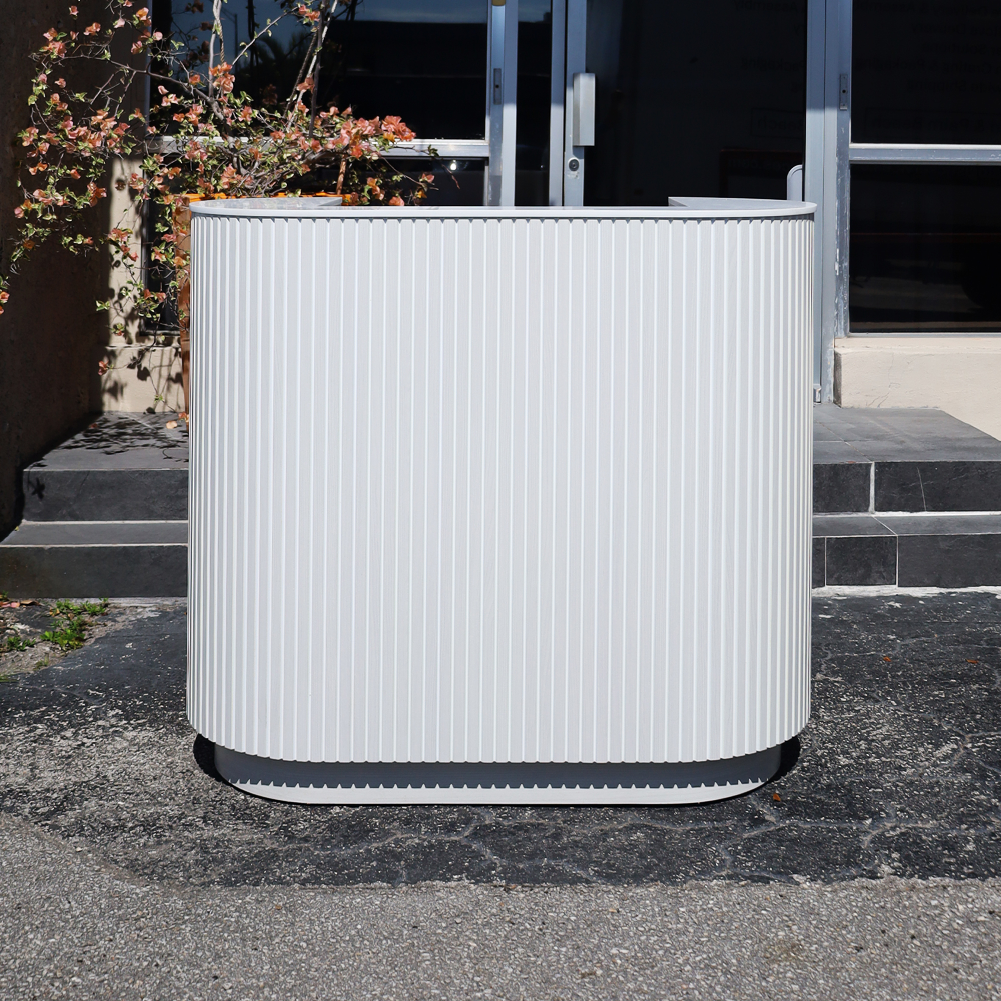 48-inch The Pill X2 Podium & Host Custom Desk White Ash Tambour front, White Solid engineered surface top, White Ash matte laminate workspace and toe-kick.