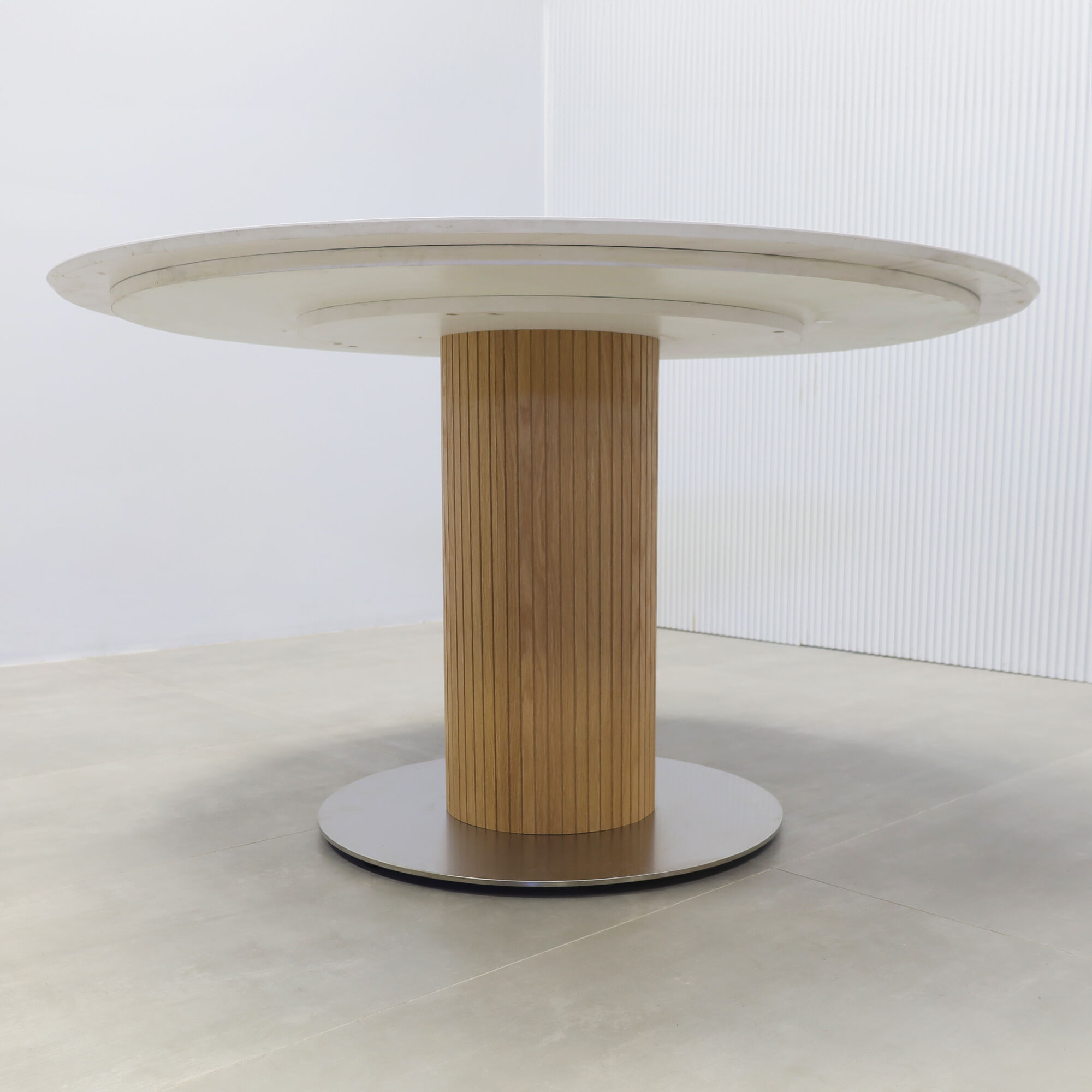 54-inches California X2 Round Conference Table with calcutta blanc engineered surface top, maple tambour pedestal, brushed stainless steel base, and Mx1 in white power box.