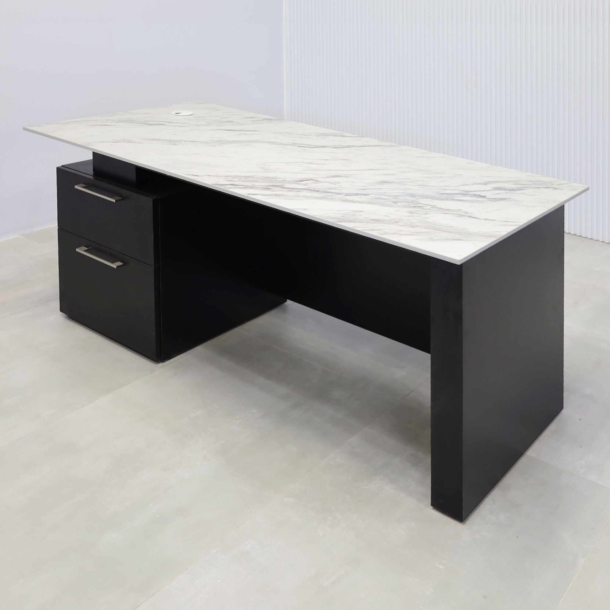 59.5-inch Avenue Straight Executive Desk with calcutta blanc engineered surface top, black matte laminate base & cabinet, and black matte laminate privacy panel.
