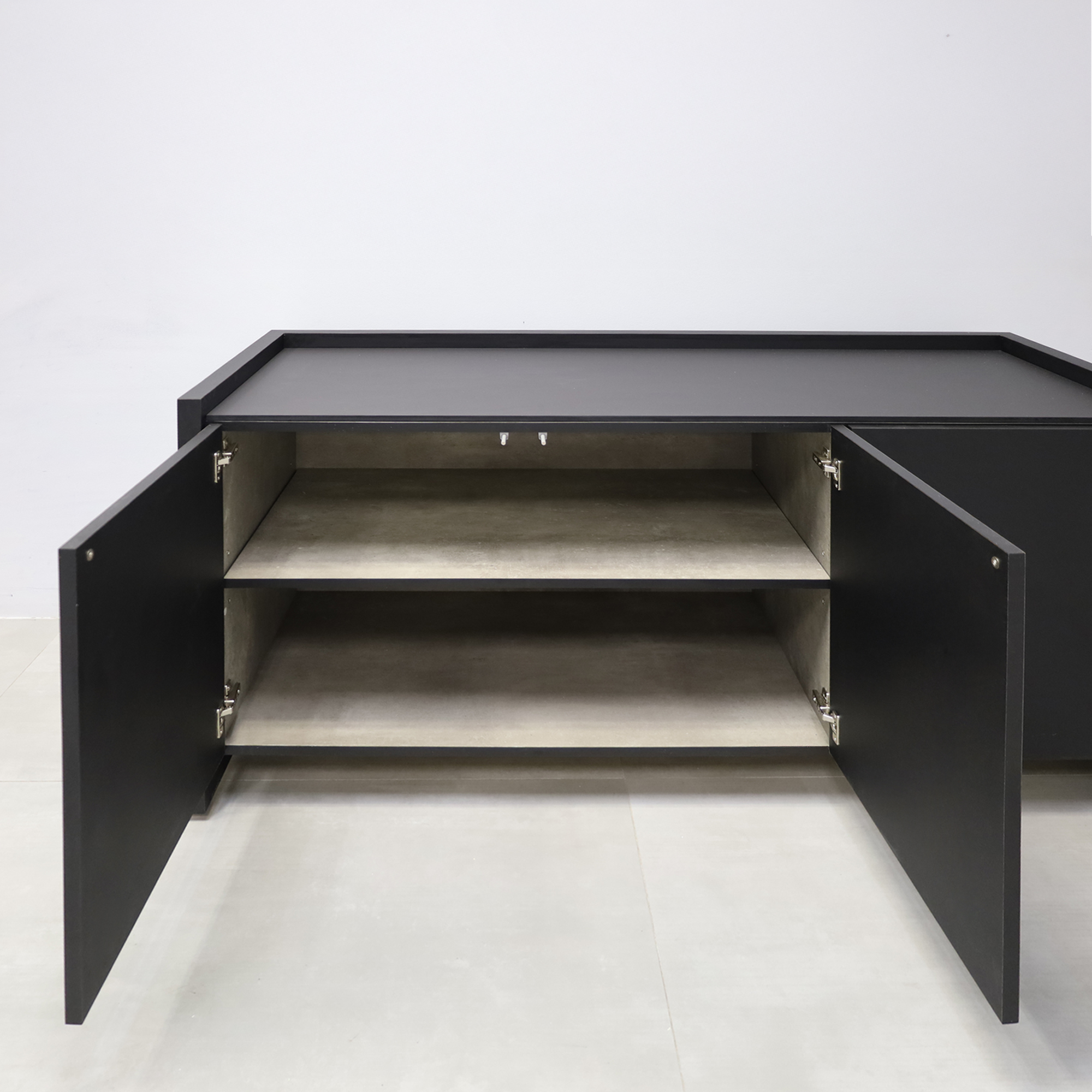 64-inch Aspen Storage Credenza with 1/2 black tracless engineered surface top, black traceless laminate credenza, and metropolitan concrete PVC inside.