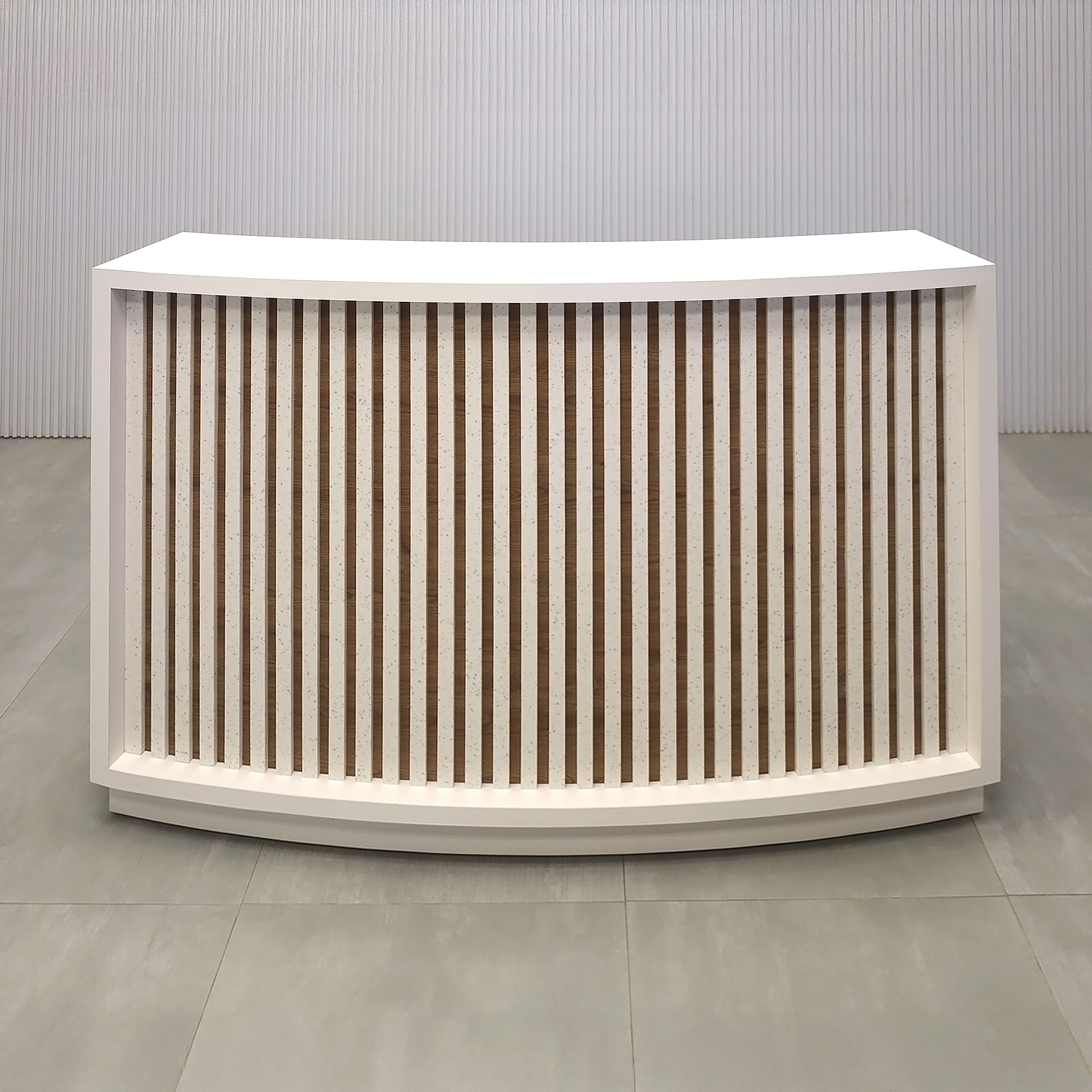 60-inch Seattle X2 Reception Desk with 413 Tumbled Glass engineered surface (Special Color) slats. Dover Off-White matte laminate counter & workspace. Spiced Chestnut matte laminate background and White LED with remote control.
