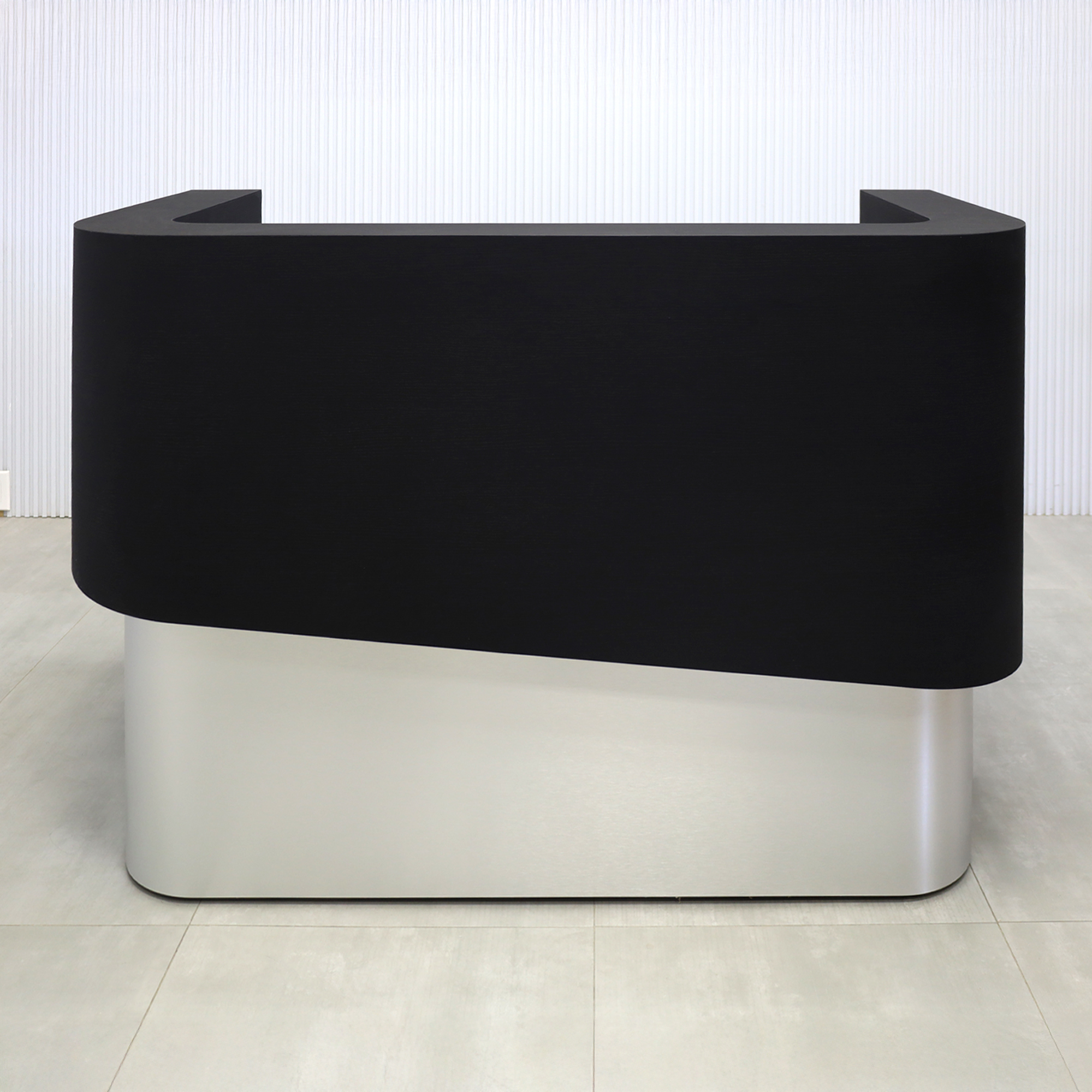 60-inch Nola Curved Custom Reception Desk with Black Cider matte laminate workspace and counter. Base in Brushed Aluminum finish and White LED.