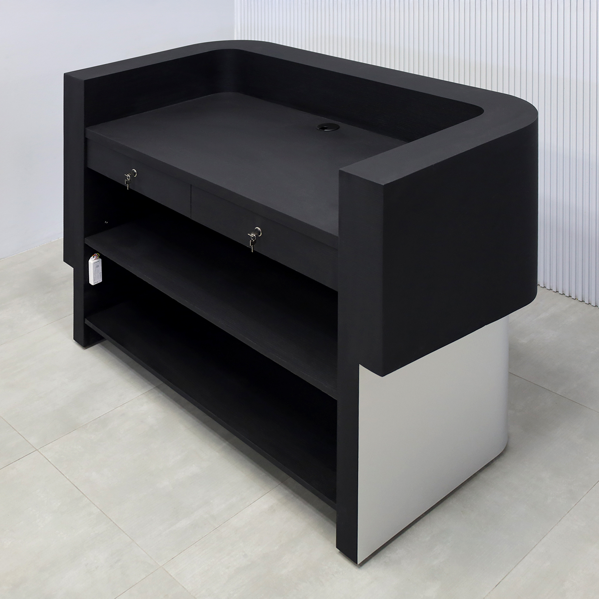 60-inch Nola Curved Custom Reception Desk with Black Cider matte laminate workspace and counter. Base in Brushed Aluminum finish and White LED.