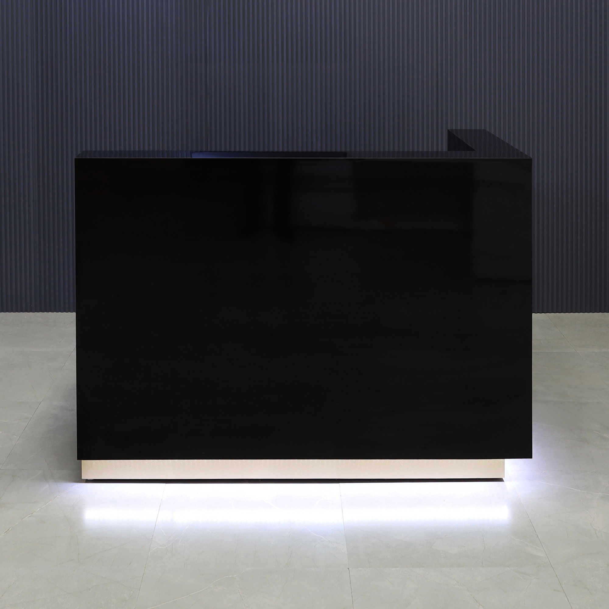 60-inch Dallas L-Shape Custom Reception Desk, right side l-panel when facing front in black gloss laminate main desk and gold toe-kick, with white LED, shown here.