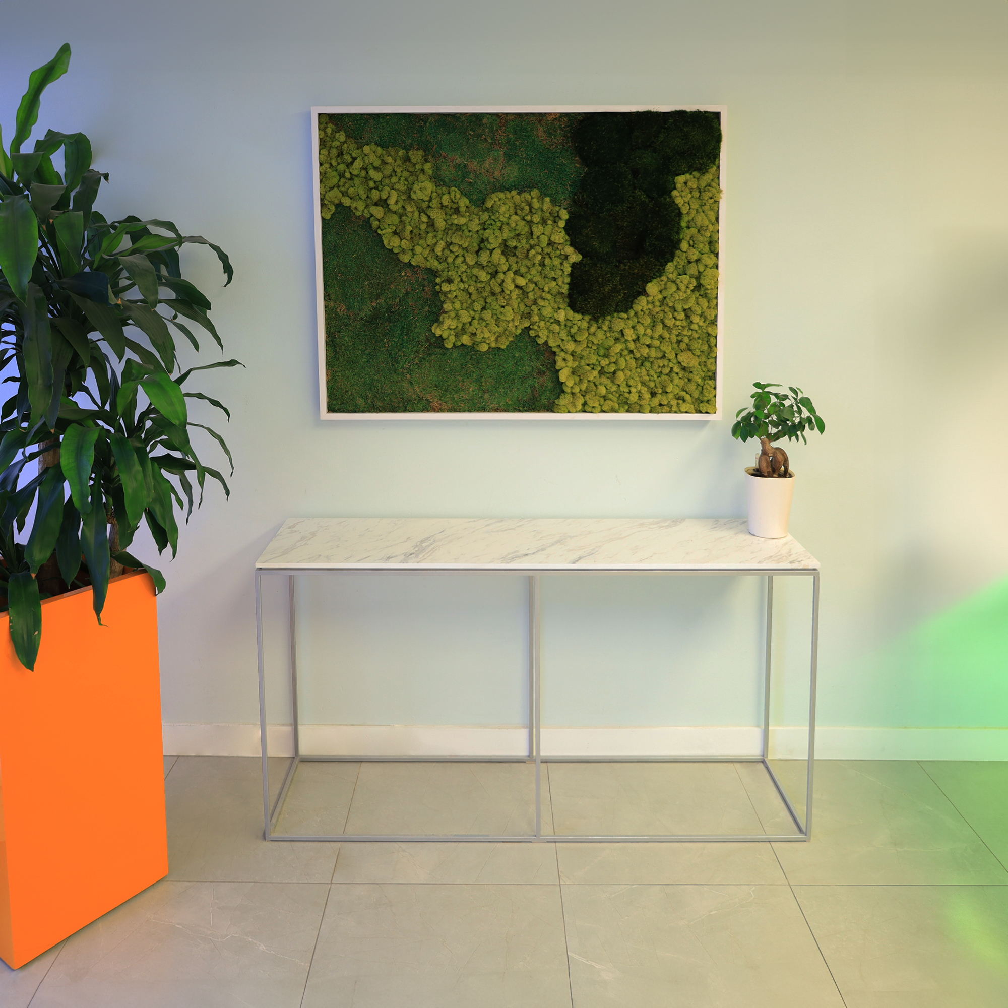 60-inch Aspen Console Table in 1/2" calcutta blanc engineered surface top and silver metal frame, shown here.