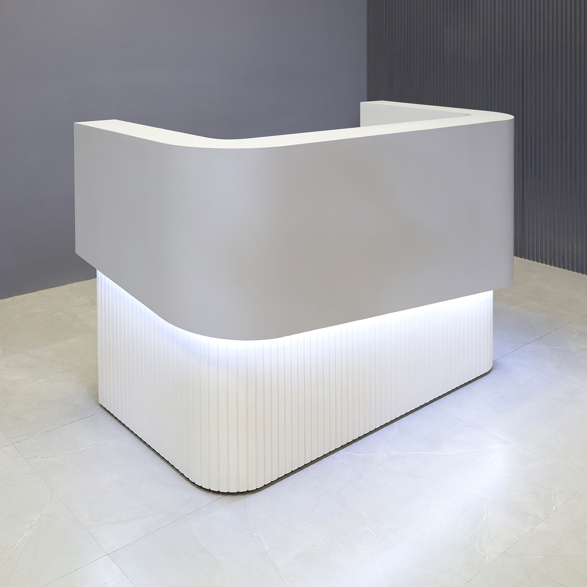 60-inch Nola Curved Reception Desk in folkstone gray matte laminate counter & inside desk, white tambour outside desk, and warm white LED.