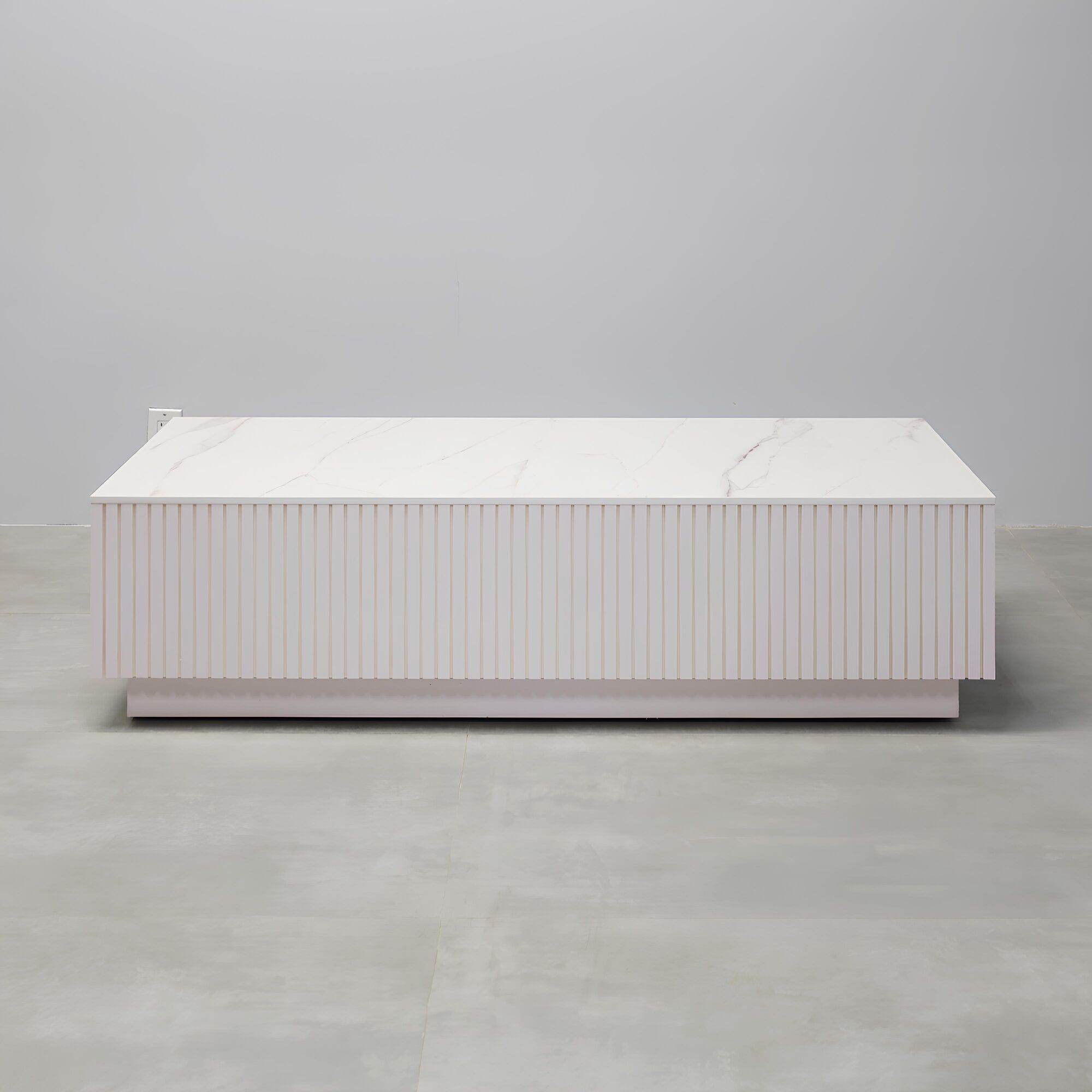 60-inch Norfolk Rectangular Lobby Table with solenne engineered surface top, white gloss tambour side table, and white gloss laminate toe-kick.