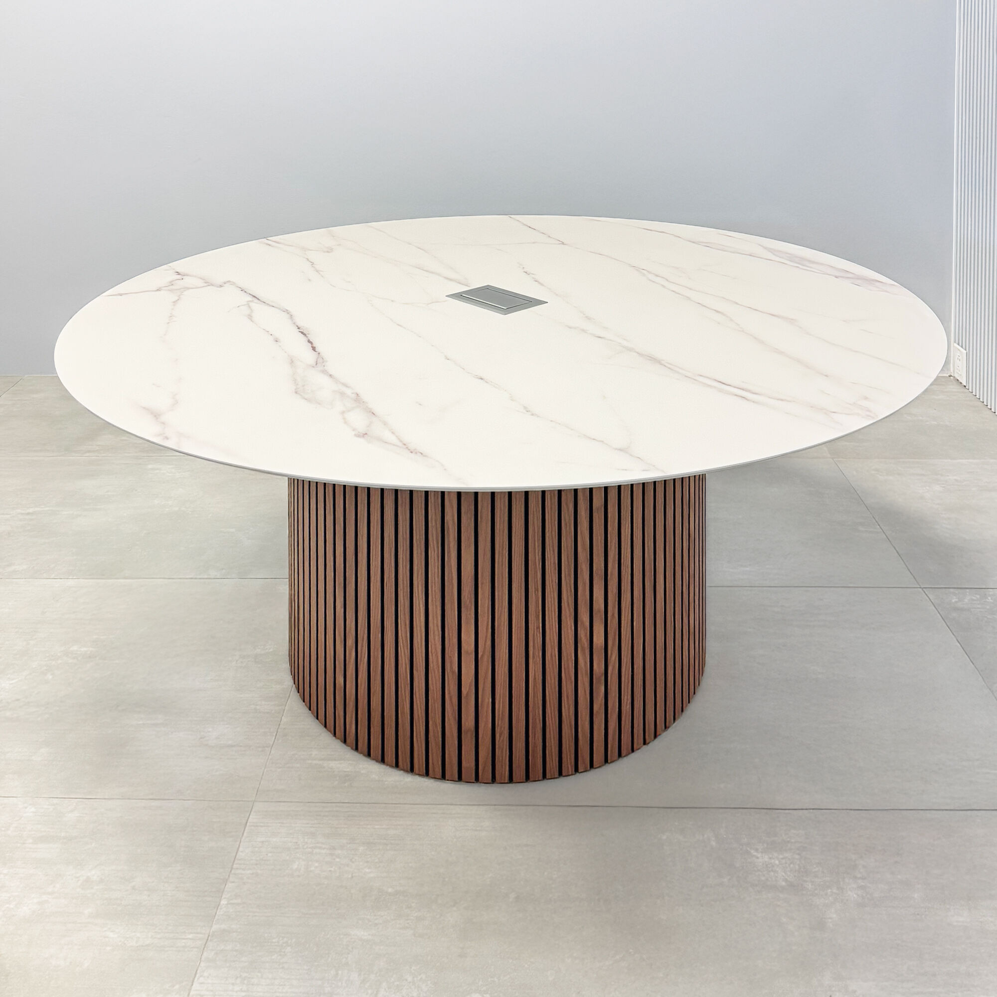 60-inch Aurora Round Conference Table with solenne marble engineered surface top, walnut tambour & black background base, and mx2 power box in silver. 