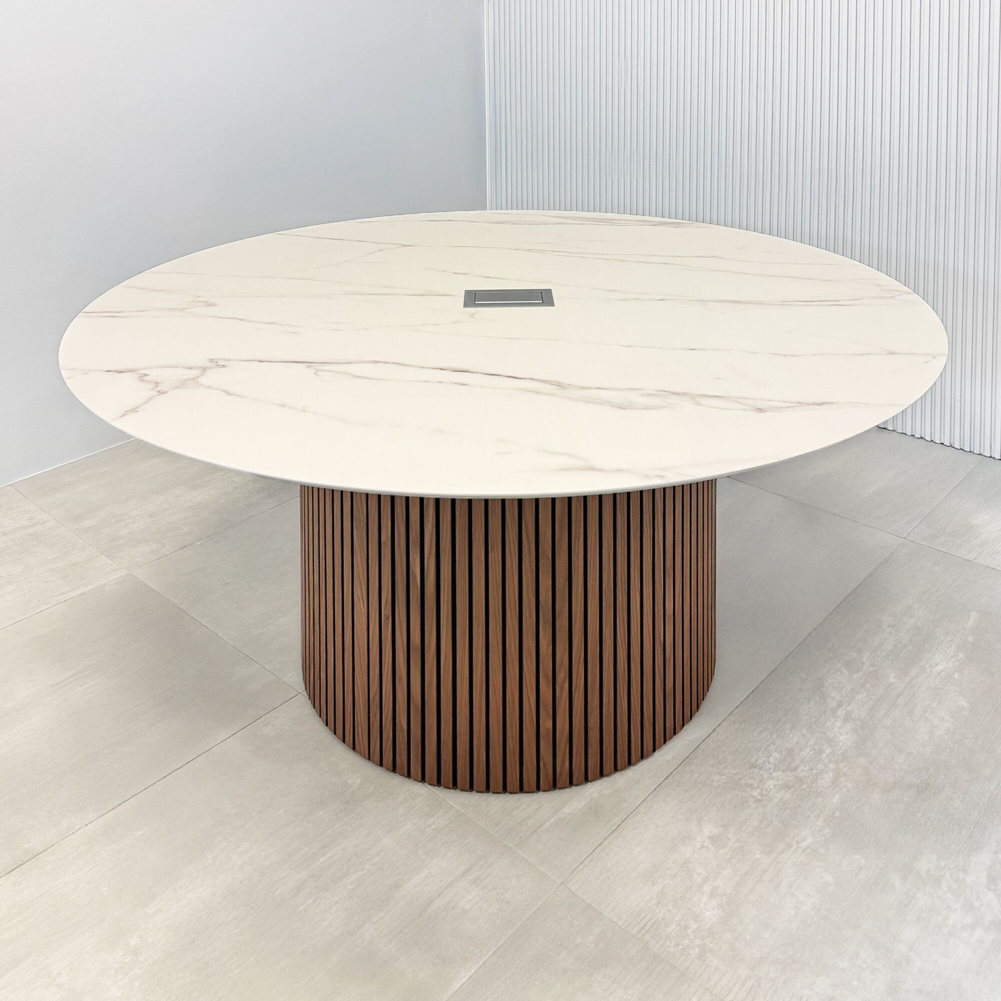 60-inch Aurora Round Conference Table with solenne marble engineered surface top, walnut tambour & black background base, and mx2 power box in silver. 