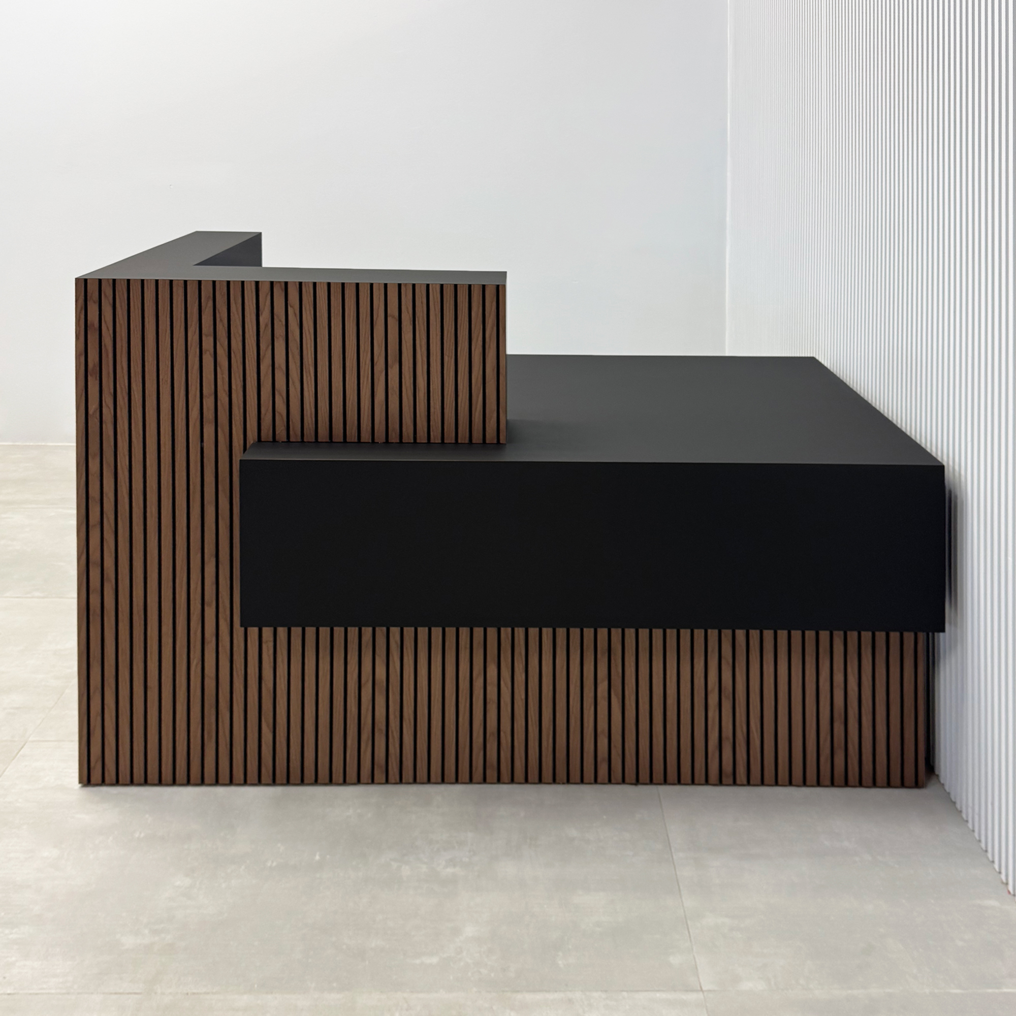 60-inch Atlanta Reception Desk with walnut tambour & black background counter, black traceless laminate workspace & storage, and black traceless laminate accent front panel.