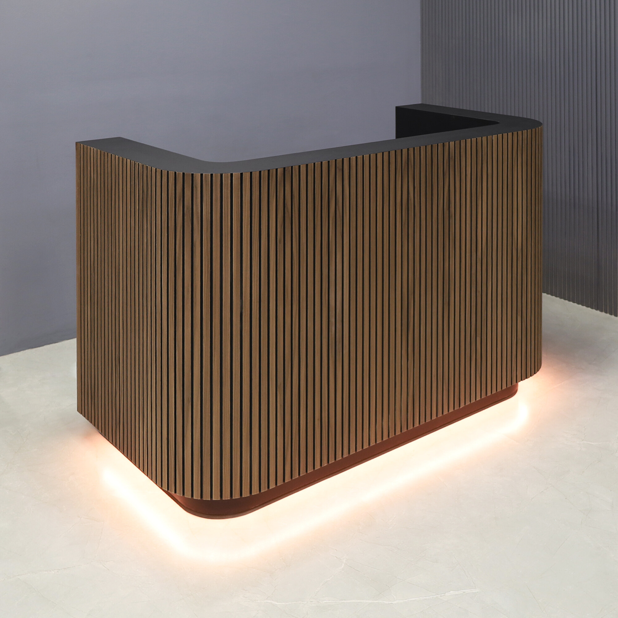 60-inch Nola Custom Reception Desk in walnut tambour main desk and black traceless laminate workspace and toe-kick, with warm white LED, shown here.