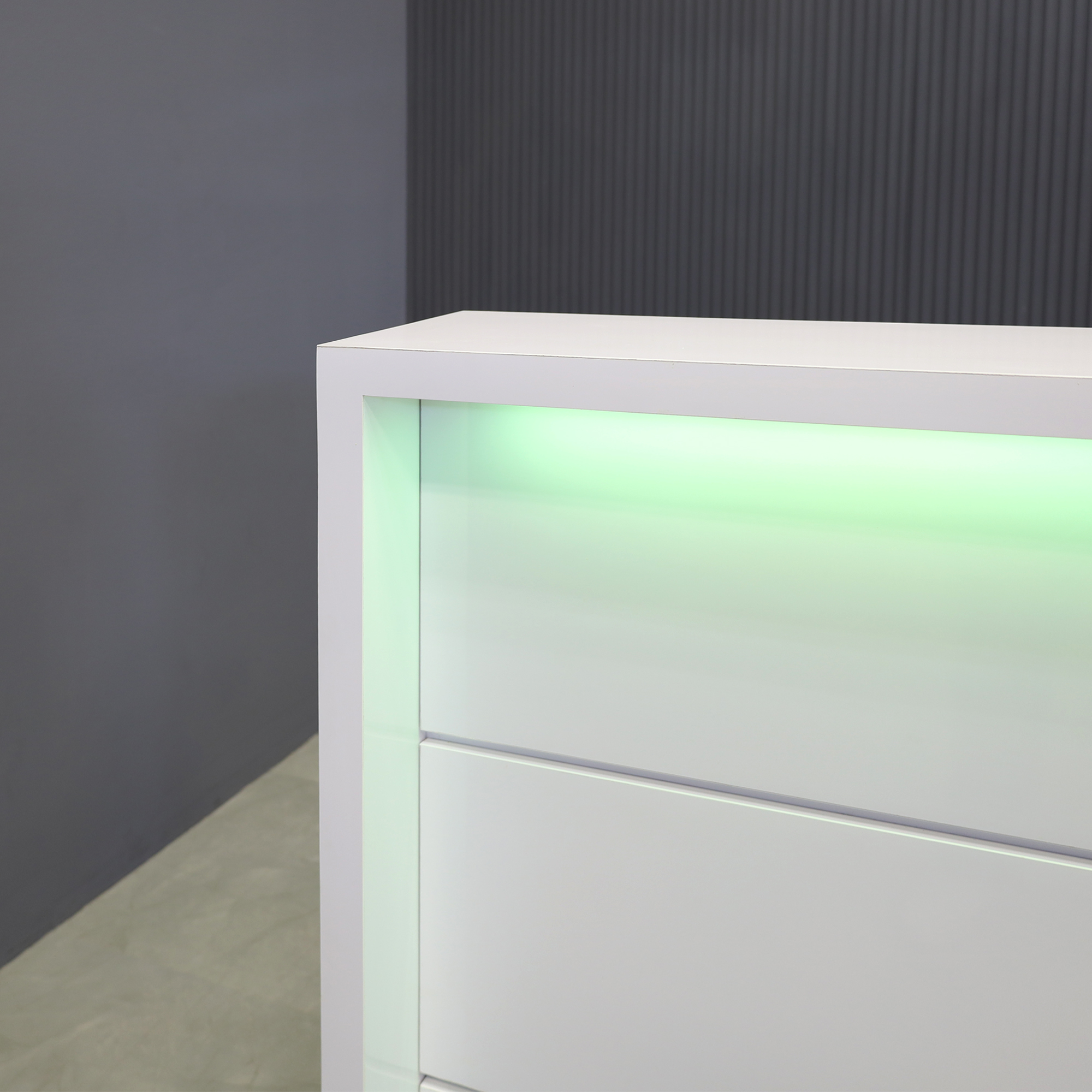 60-inch New Jersey Reception Desk in white gloss laminate desk and front panels, brushed aluminum toe-kick, with color LED shown here.