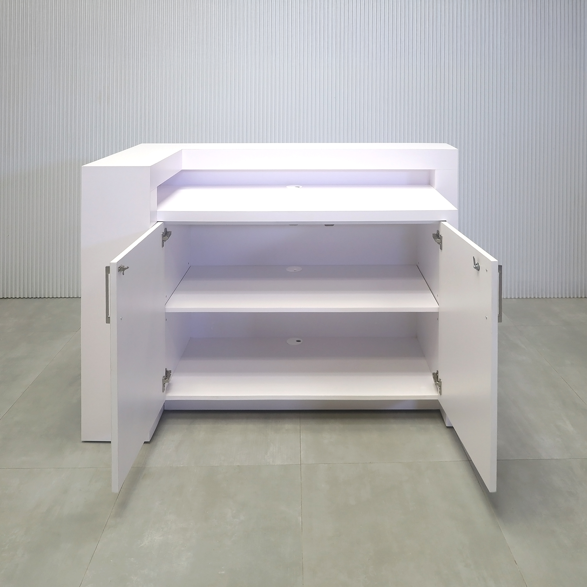 60-inch New York L-Shape Reception Desk with White Matte laminate counter, White Matte laminate workspace, White Matte laminate accent panel, Solenne Marble slats, and Color LED.