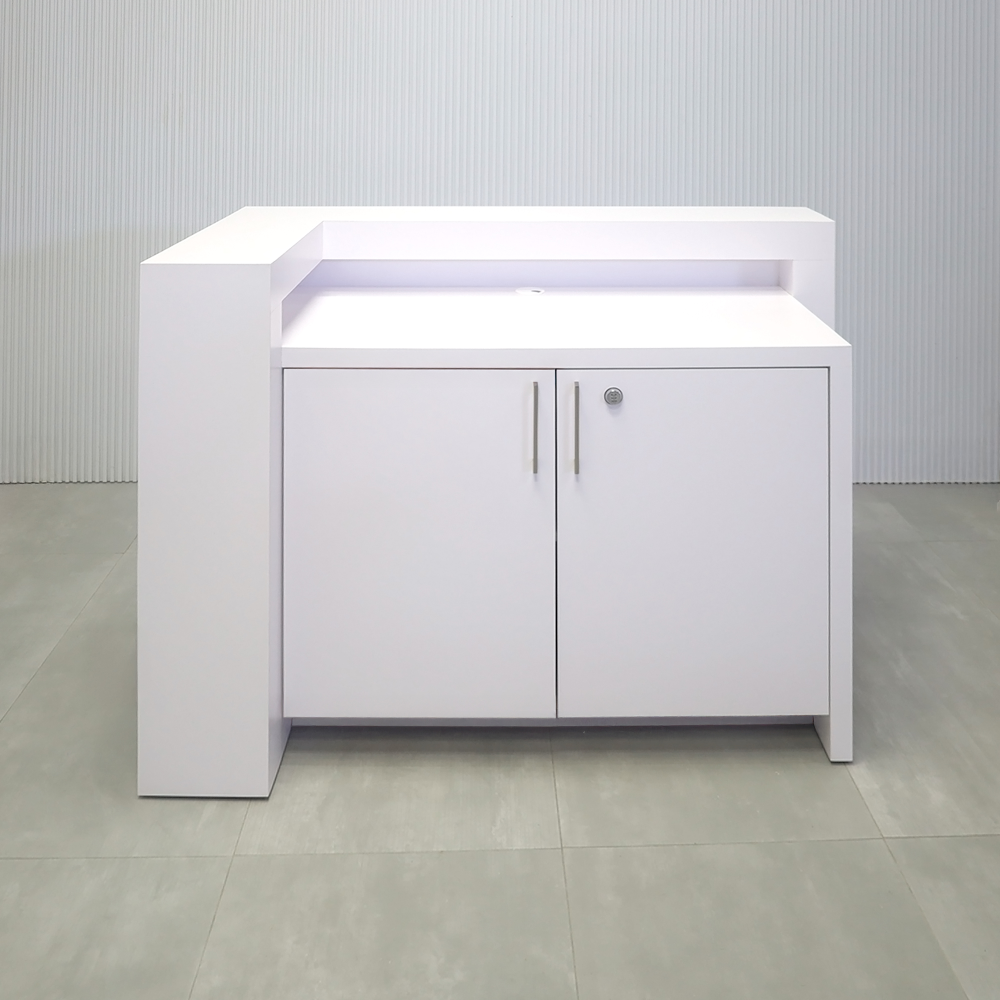 60-inch New York L-Shape Reception Desk with White Matte laminate counter, White Matte laminate workspace, White Matte laminate accent panel, Solenne Marble slats, and Color LED.