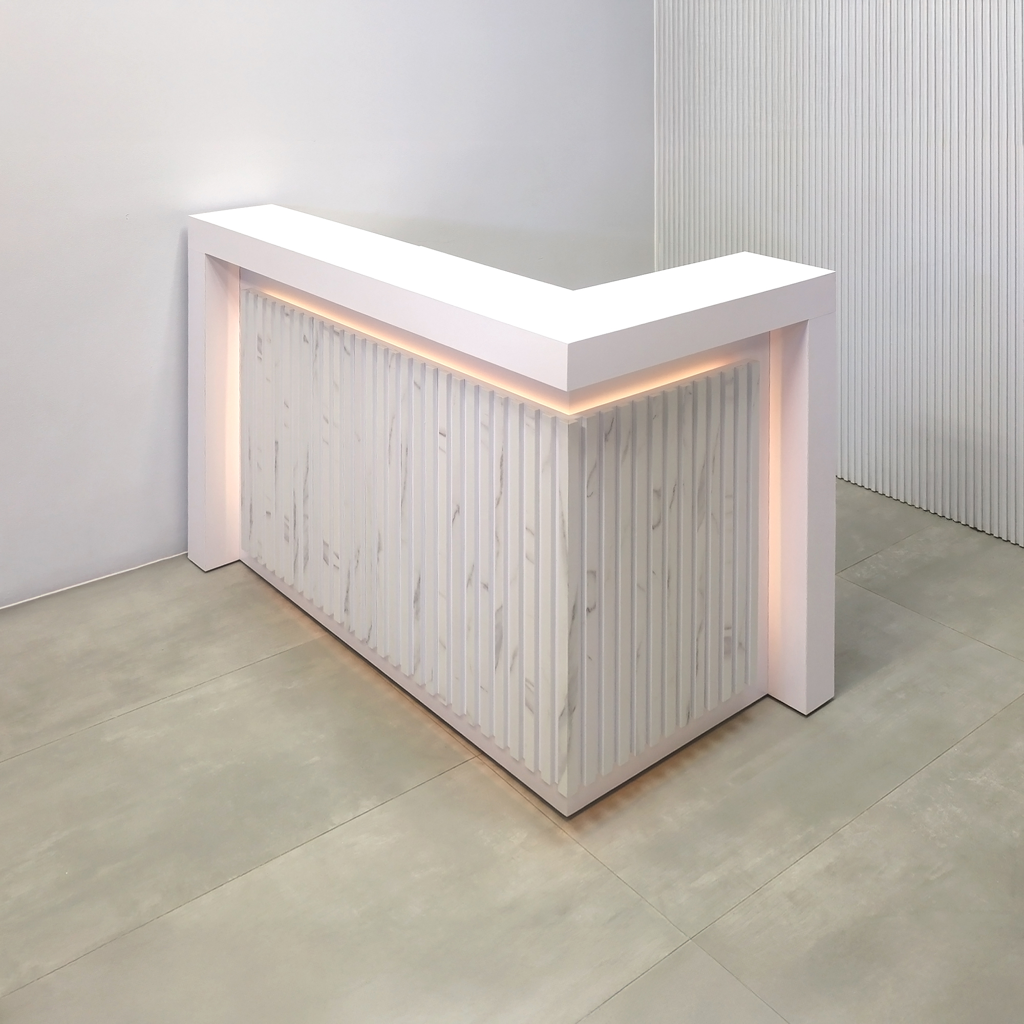 60-inch New York L-Shape Reception Desk with White Matte laminate counter, White Matte laminate workspace, White Matte laminate accent panel, Solenne Marble slats, and Color LED.